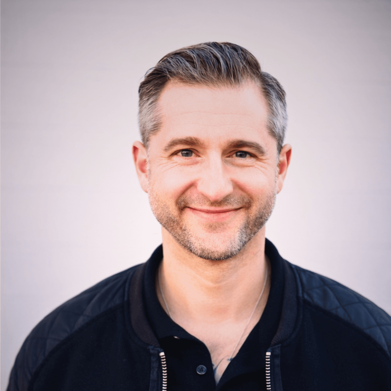 man in green crew neck shirt and black hat