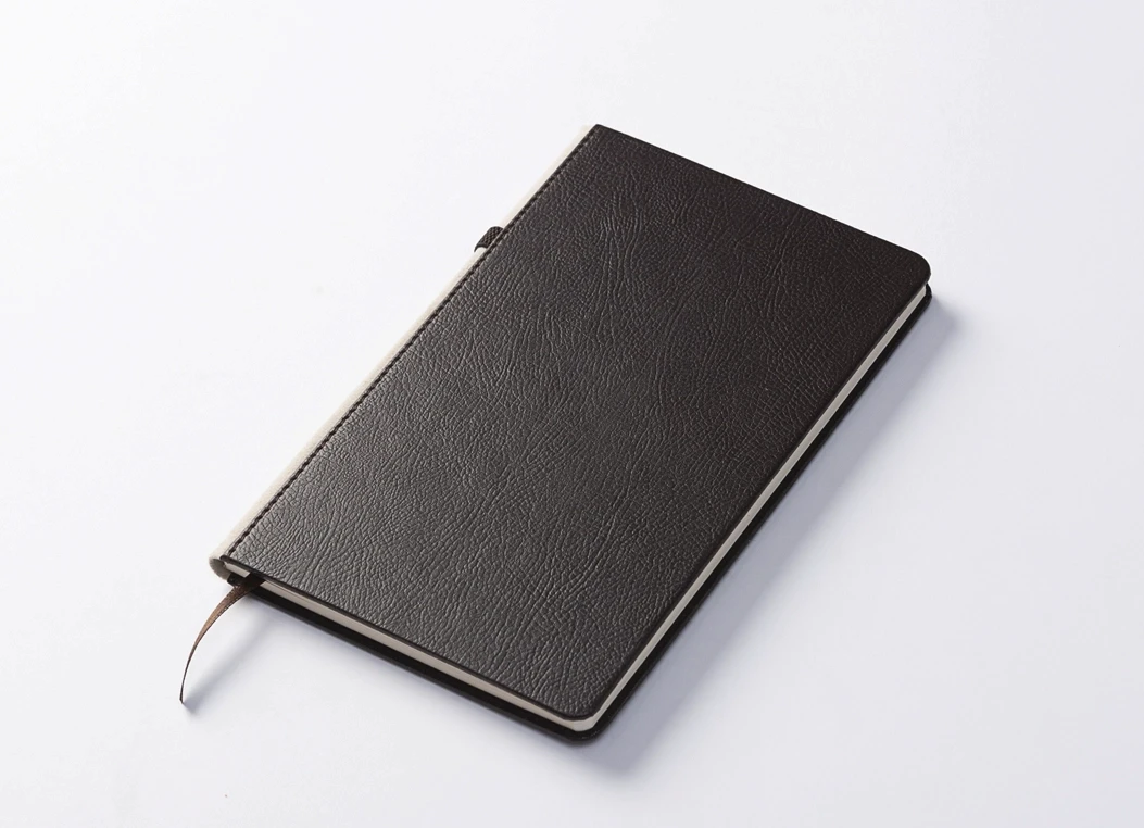 Angled view of leather-bound journal with ribbon bookmark
