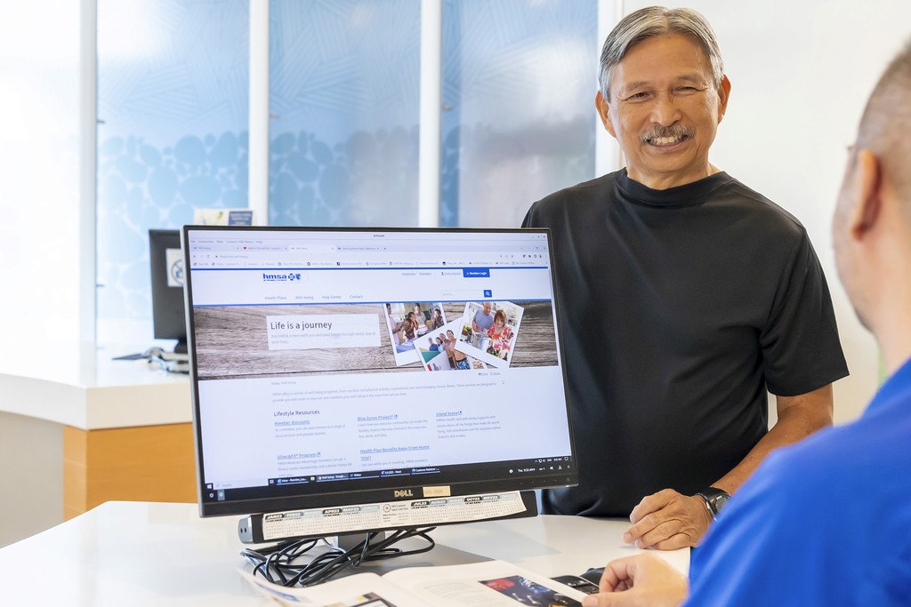 HMSA Staff speaking with members inside office
