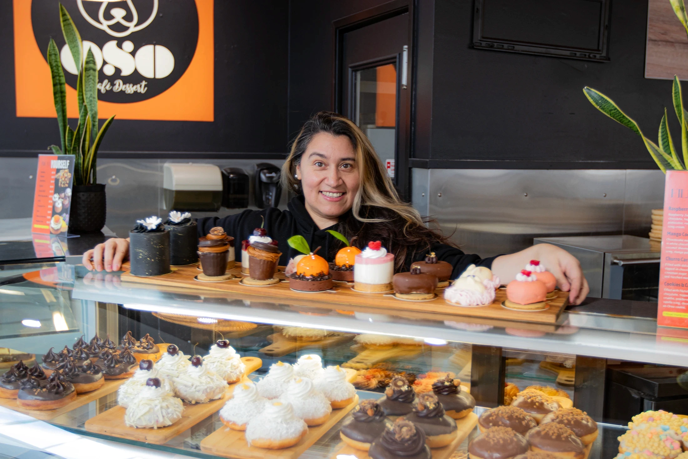 Oso Bakery worker displaying treats
