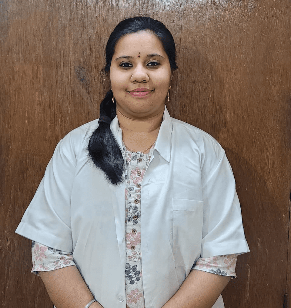 A businesswoman sitting at her desk, smiling and looking at the camera.