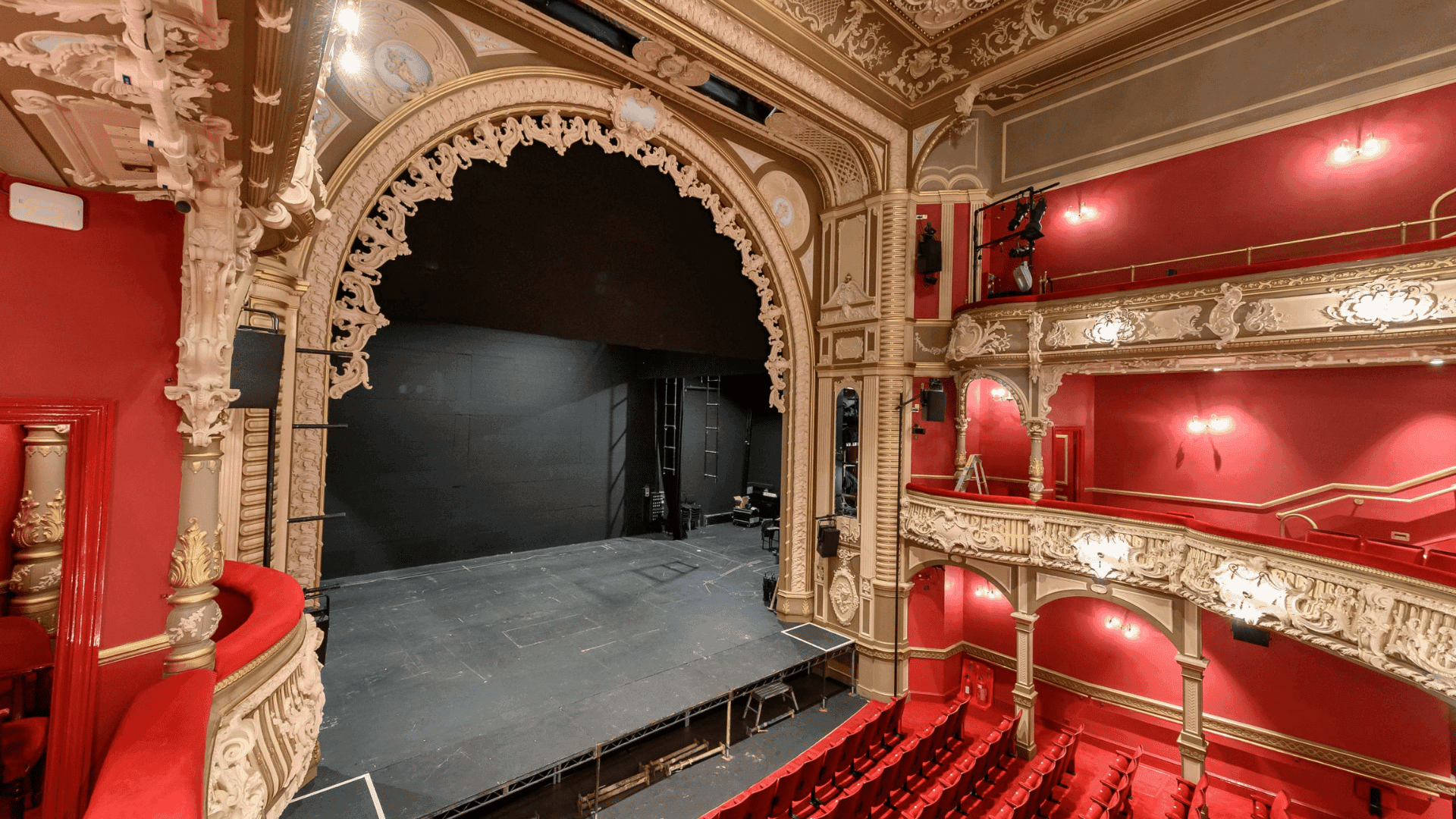 View of the stage and proscenium arch of the Lyric Hammersmith Theatre in London from the auditorium