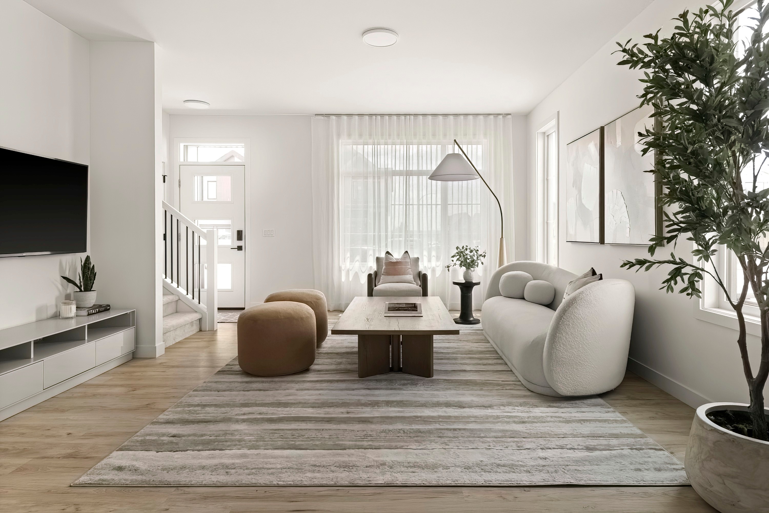 Zen Luxury Staging living room with low layered seating and floor-to-ceiling windows, staged by HAUS Interiors, Calgary