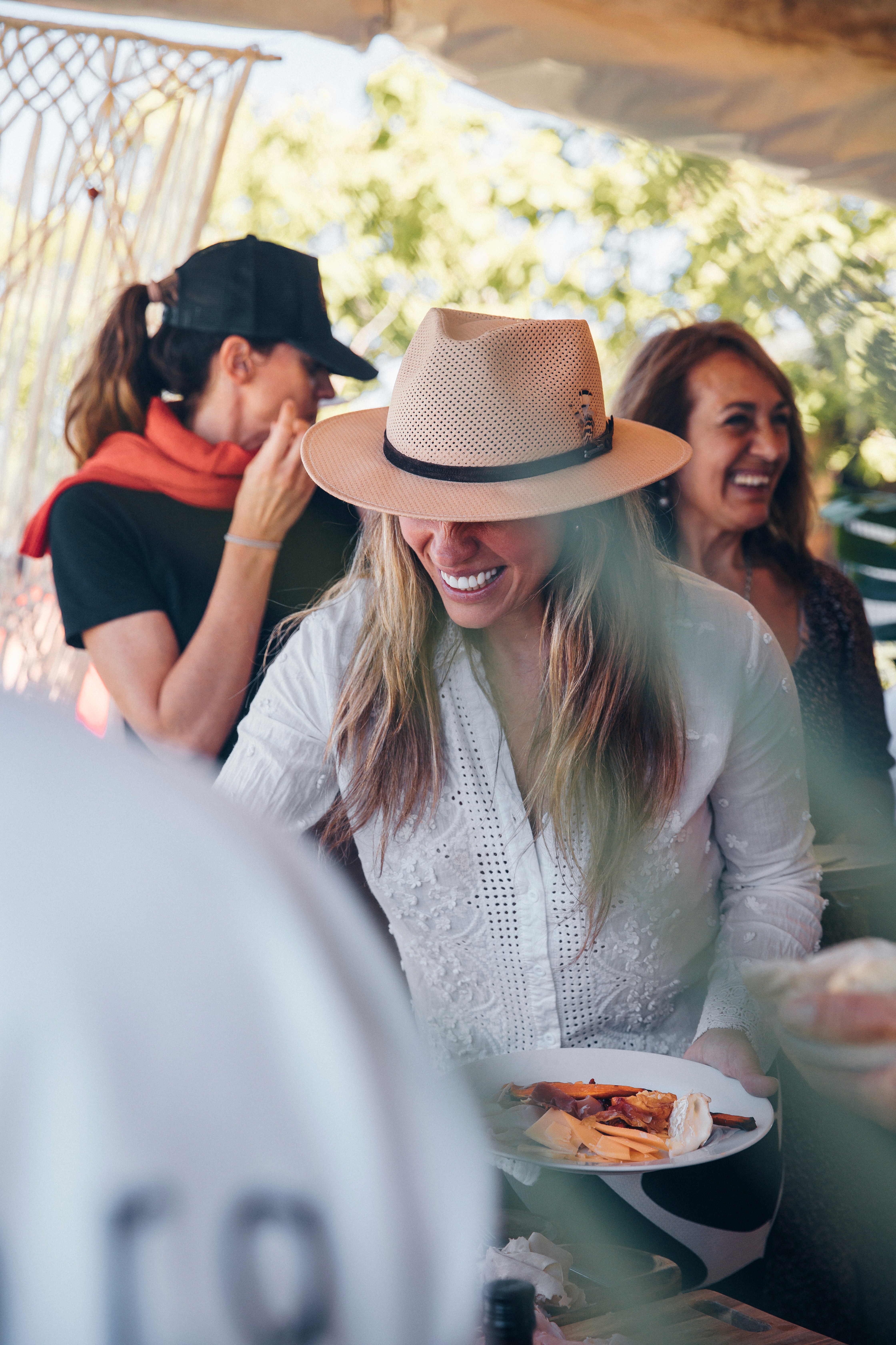 Close-up of a dark green leaf showing its textured surface and central vein against a muted background.