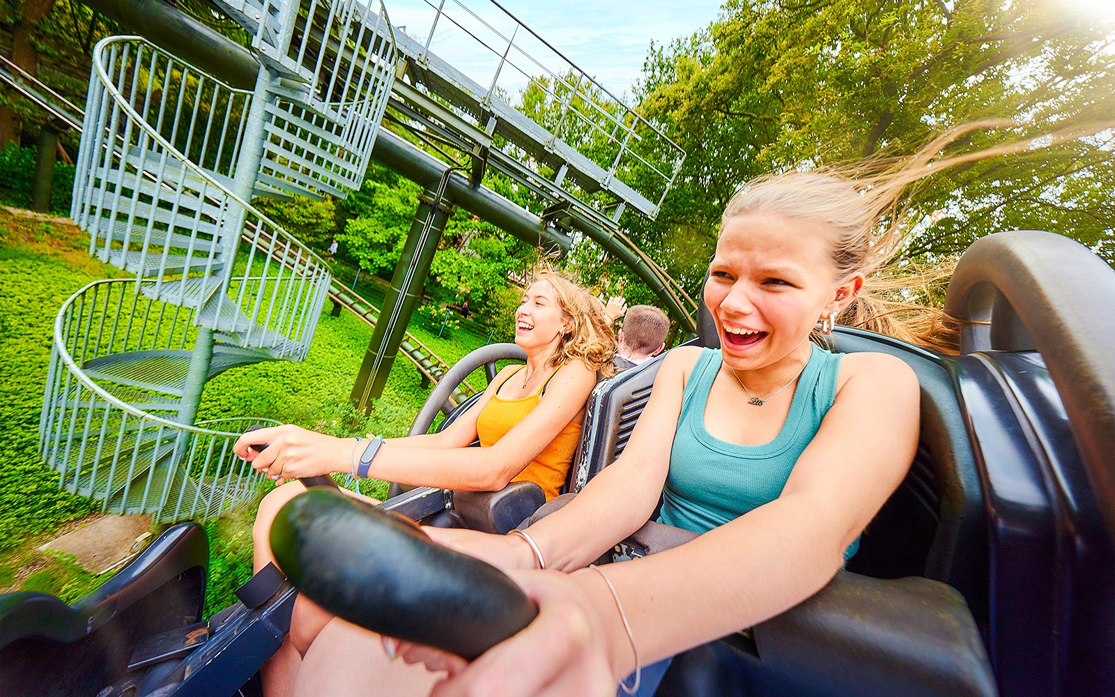 Kids enjoying a roller coaster ride at Bobbejaanland theme park.