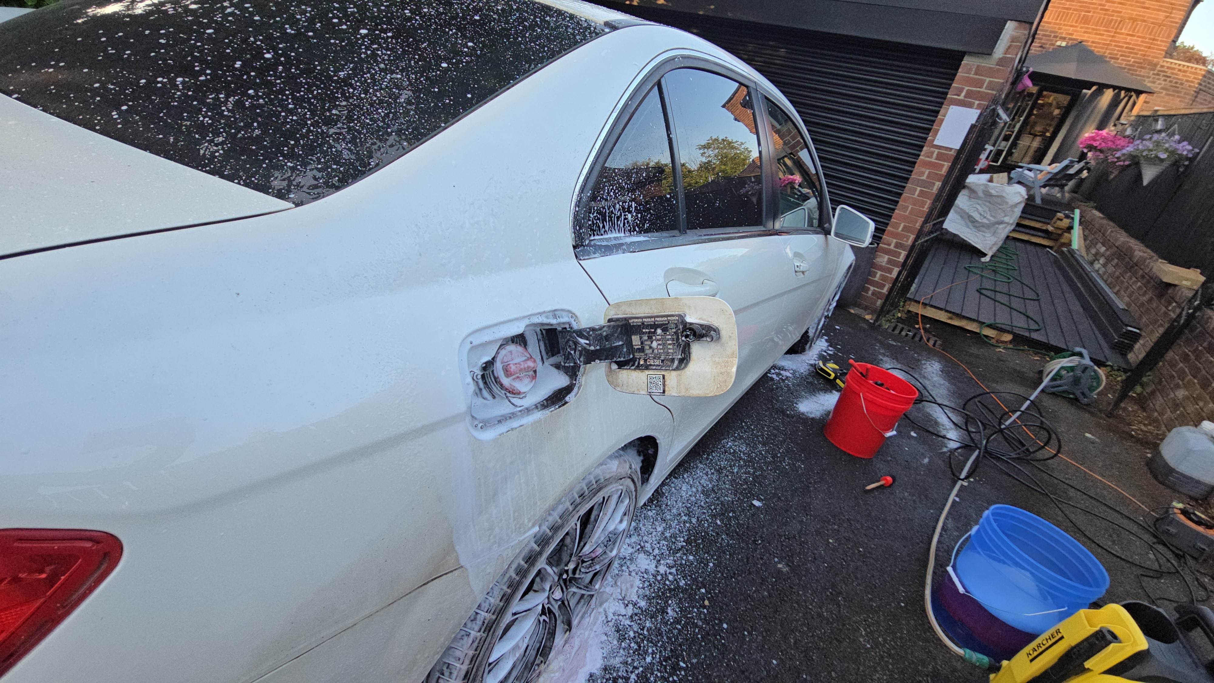 White Mercedes C-Class fuel-filler recess being detailed