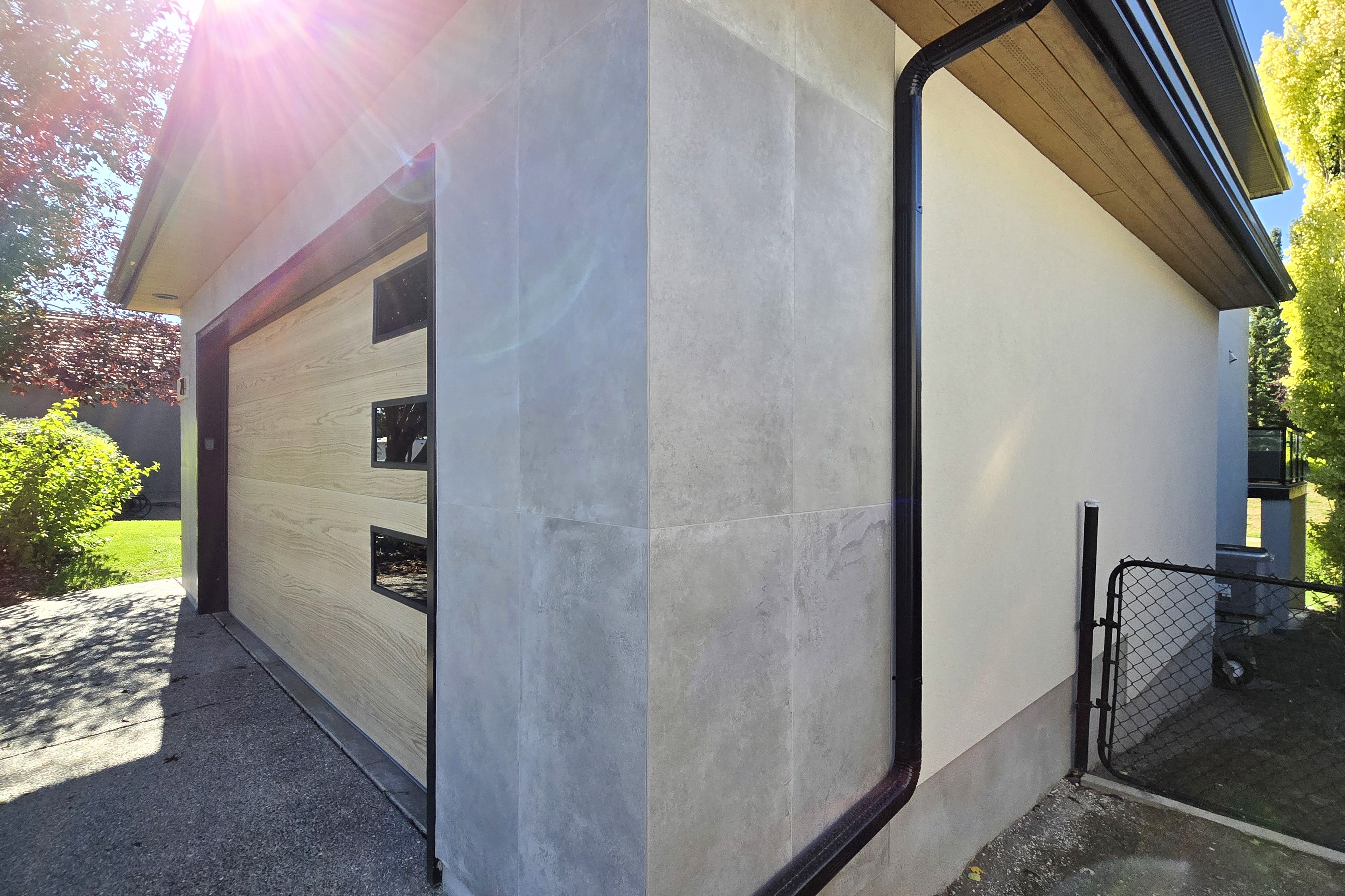 Image of KHD Homes exterior design with garage door and stone facade featuring layout design construction elements.