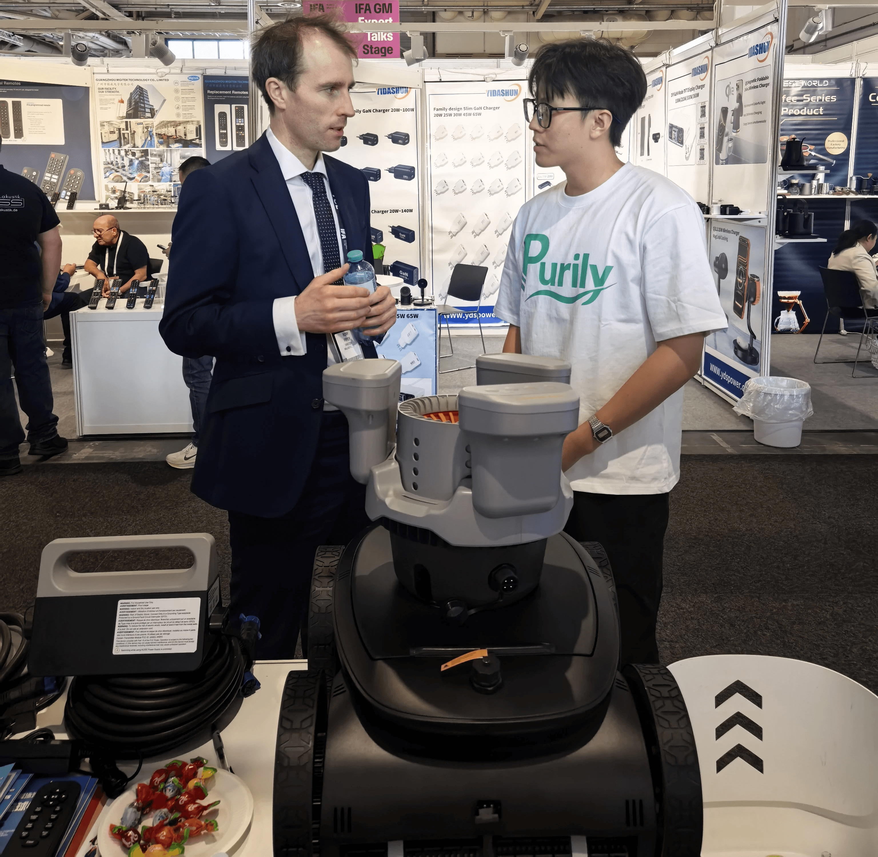 PURITY team discussing robotic pool cleaning solutions with visitors at IFA 2026