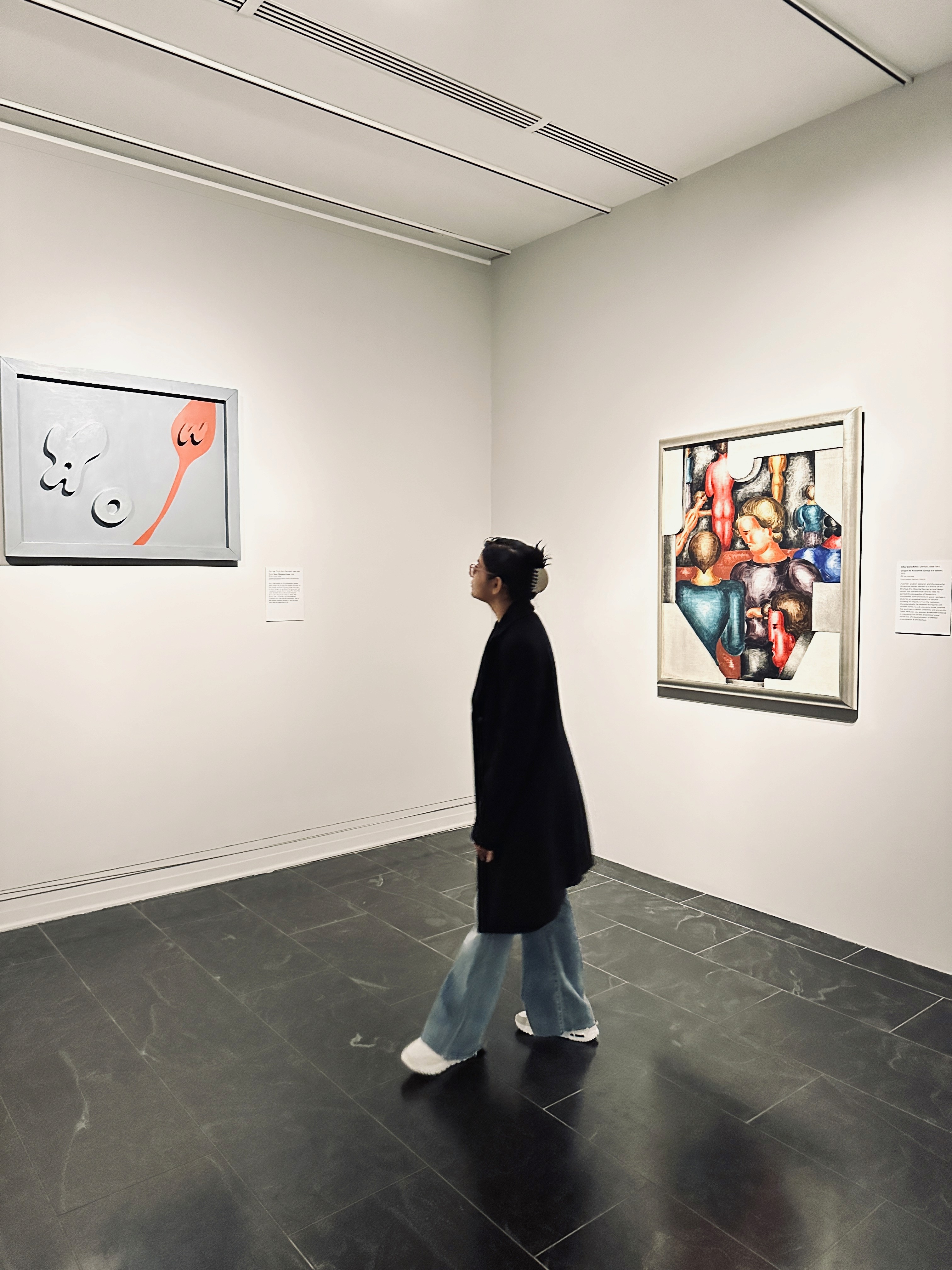 Person sitting on a ledge overlooking New York City skyline