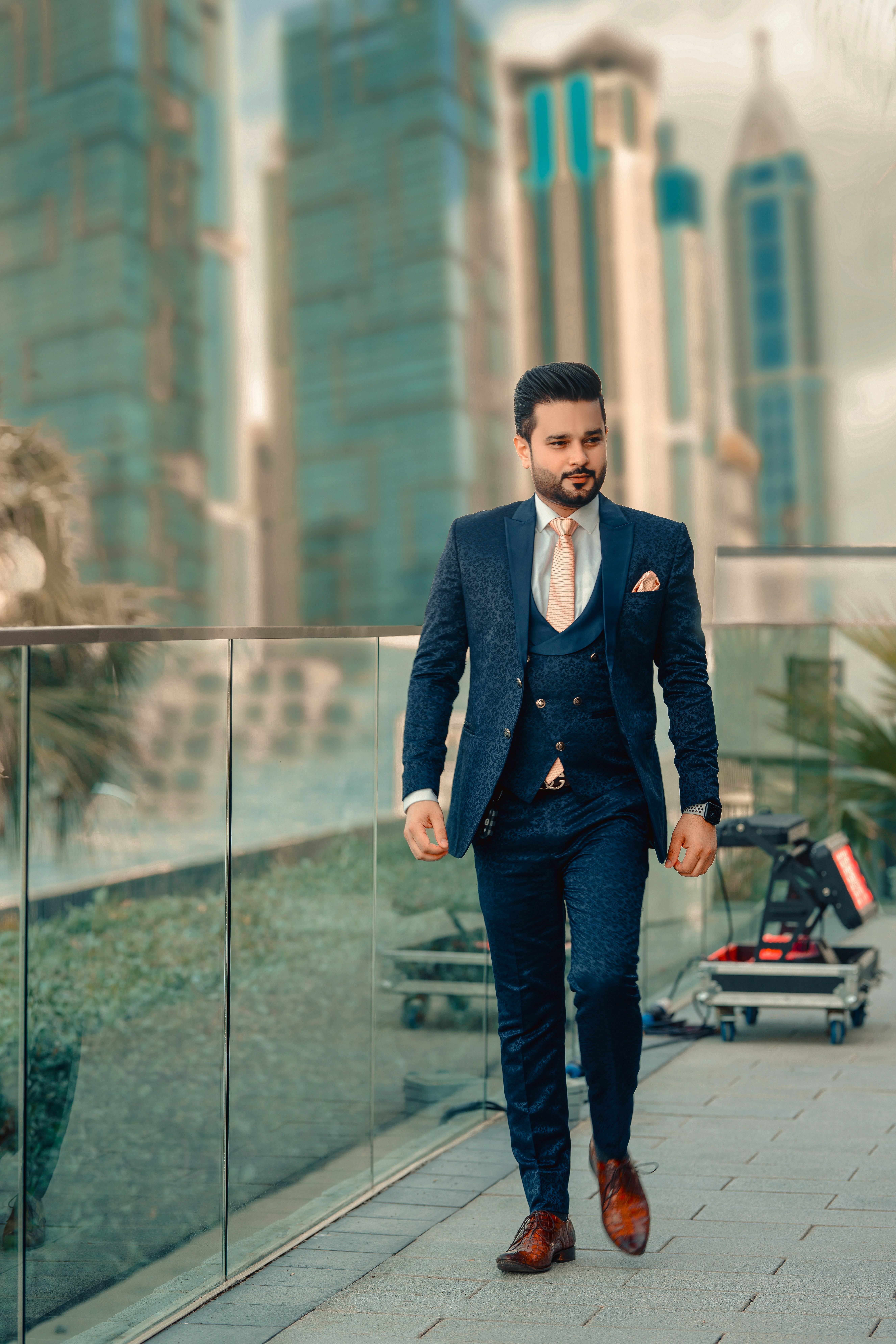 A man in a suit walking down a sidewalk