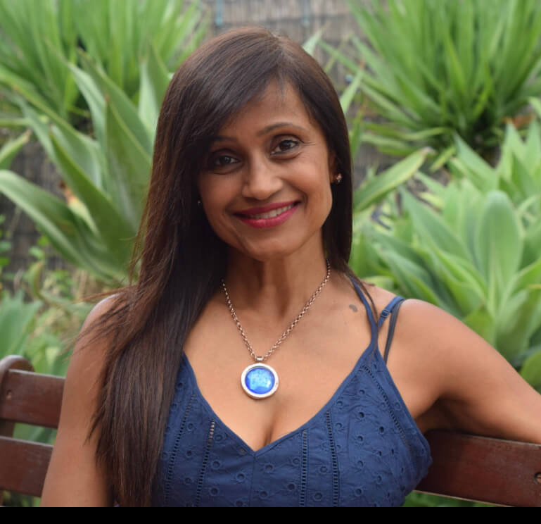 Professional photo of a health practitioner against a background with green plants