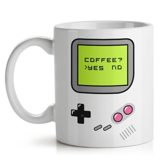 White mug designed like a retro gaming console with a green screen and button graphics