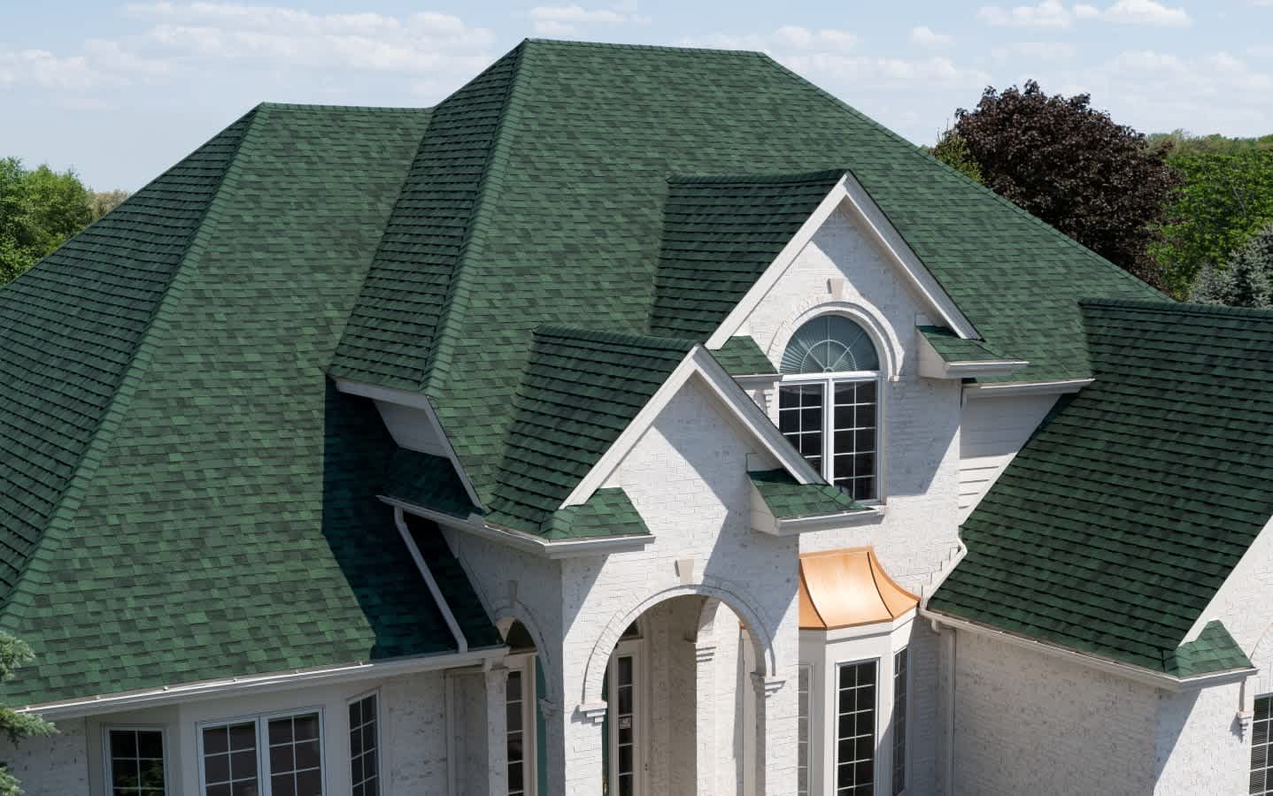 Beauty shot of a beautiful home with Owens Corning TruDefinition Duration shingles in Chateau Green color.