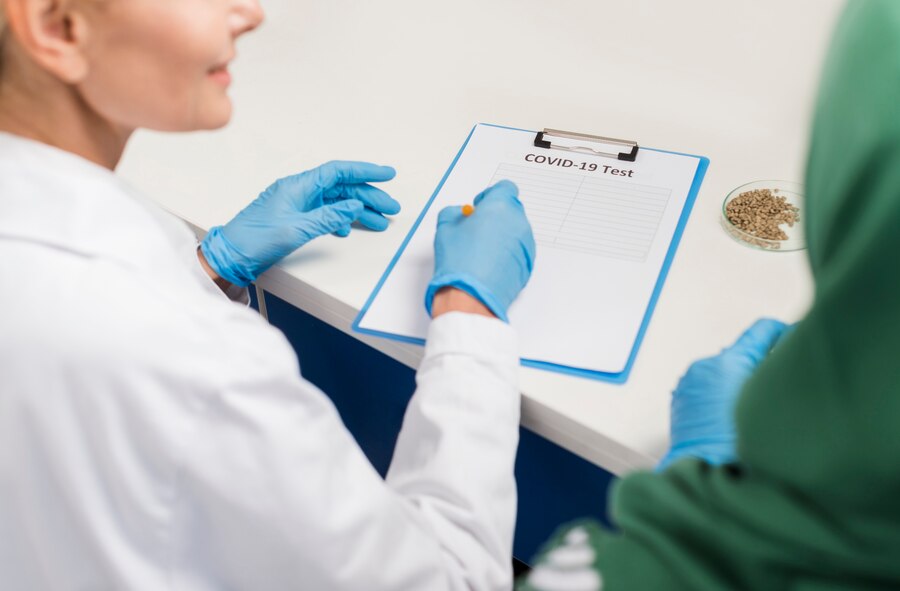 A doctor discussing reports of his pateint with the nursing staff.