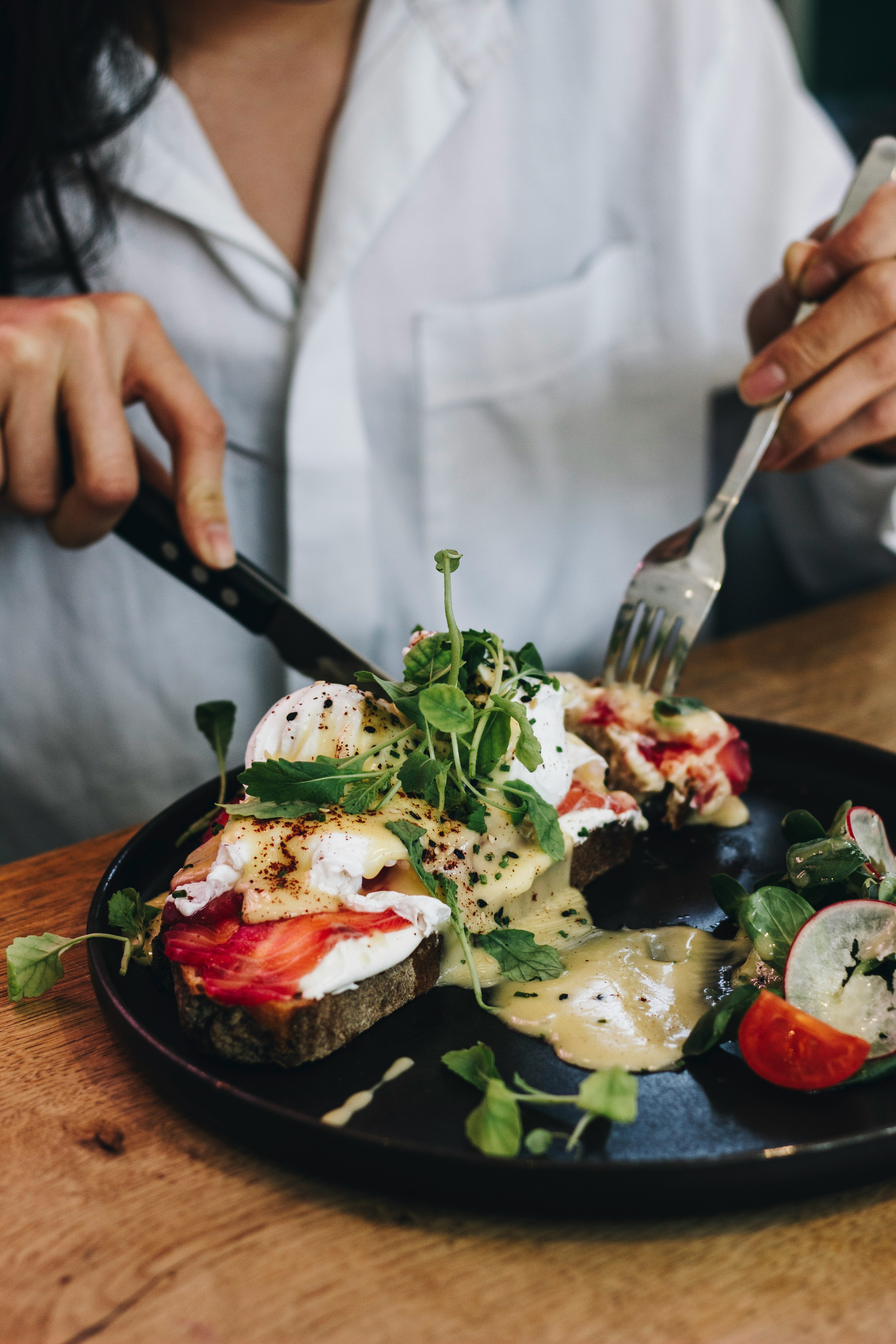 A plate of eggs and greens on toast, protein-rich foods that help runners repair muscle