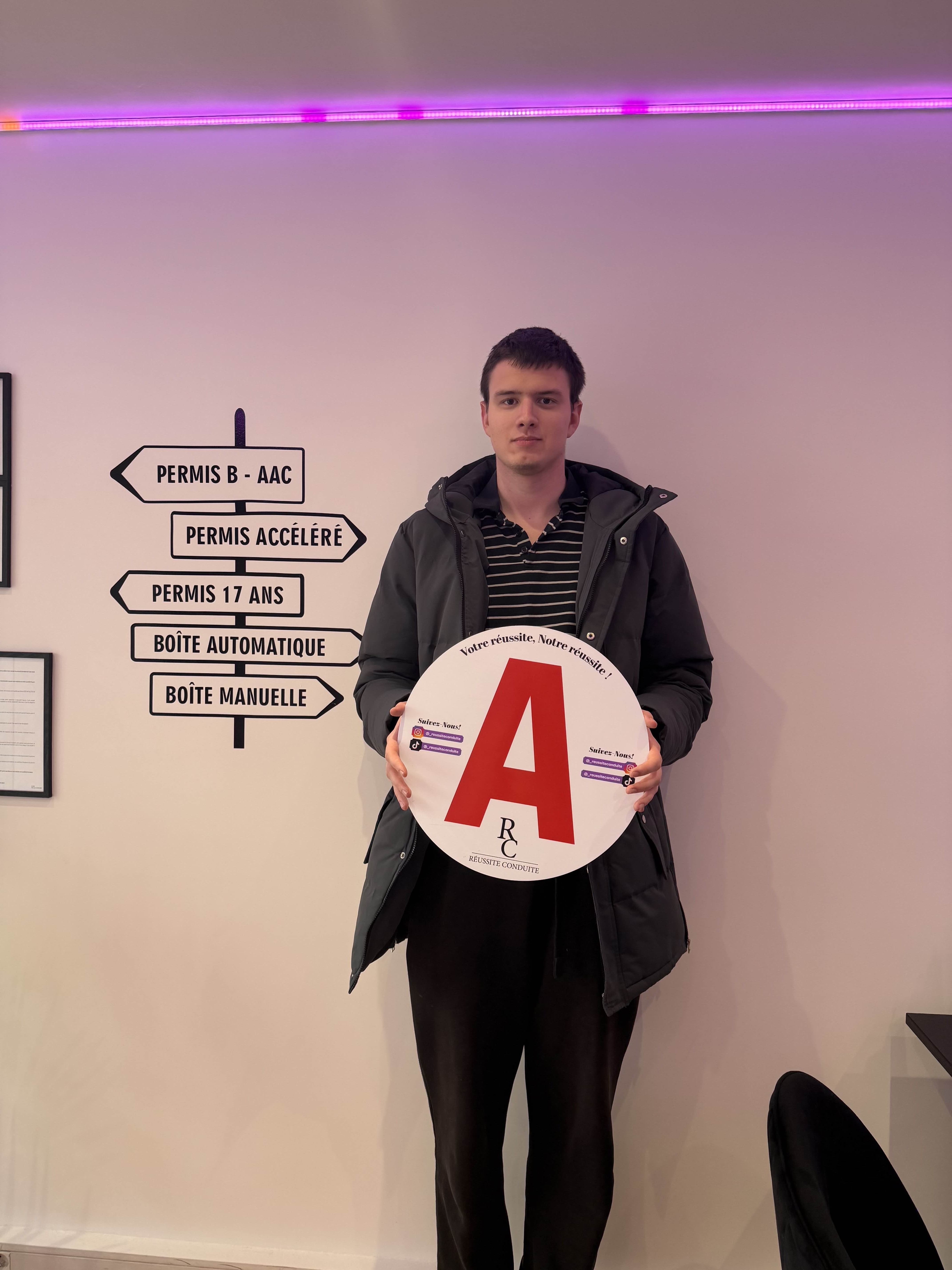 man in black jacket holding blue tablet computer