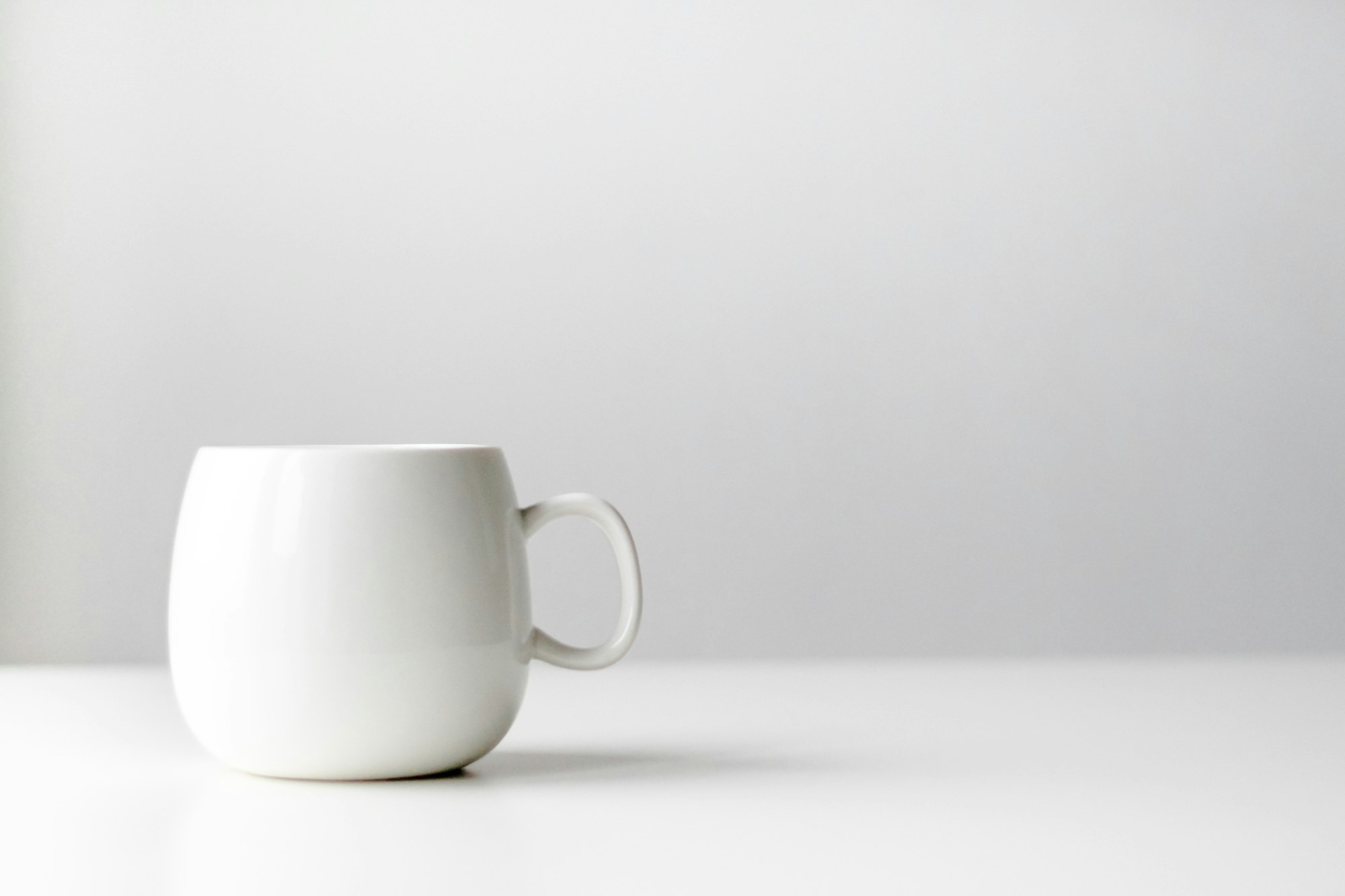 A white mug on a white table