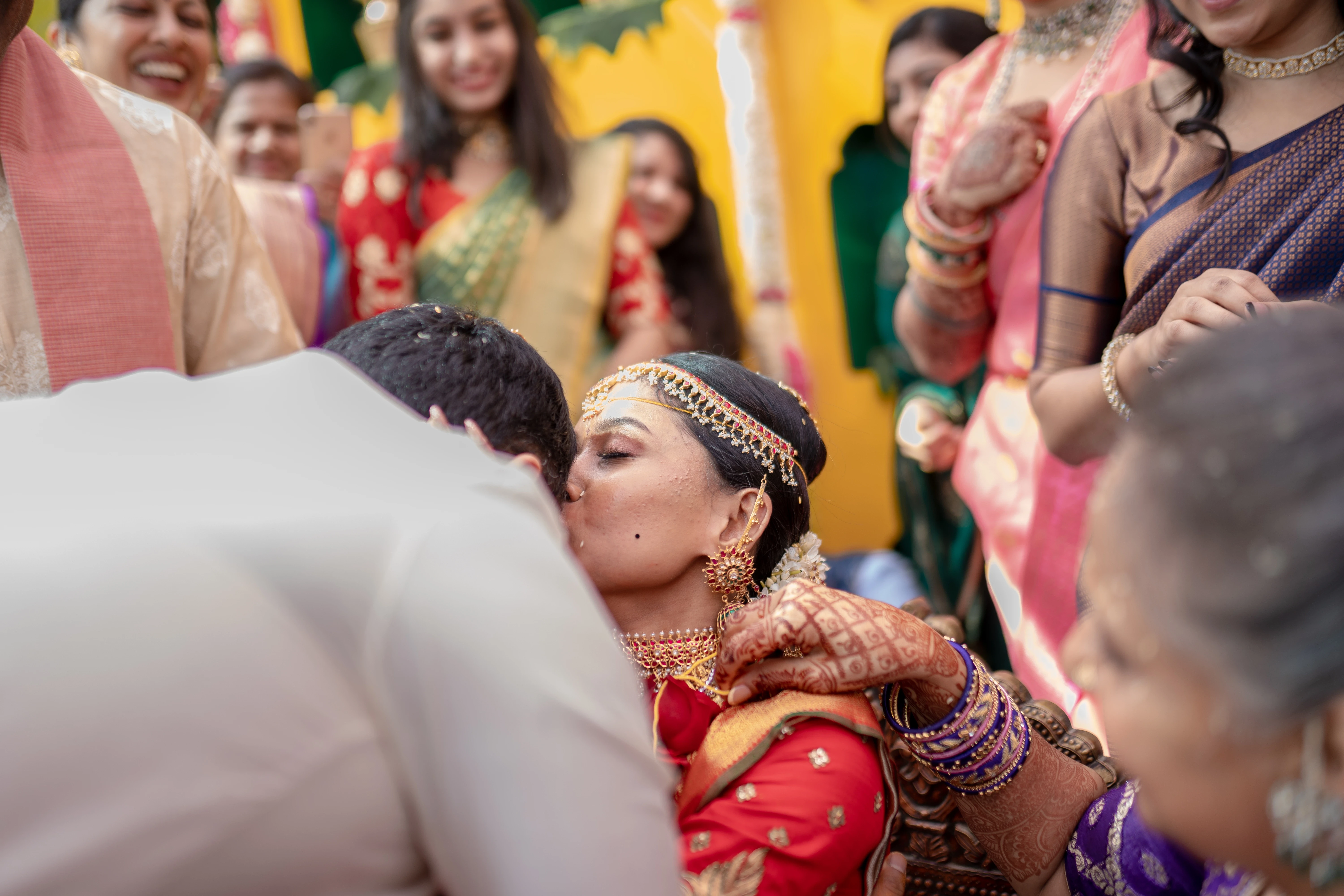 A couple dressed in traditional Indian attire smiles together in a timeless black and white photograph. Photo by Out of The Blues Fine Art Wedding Photography in Hyderabad.