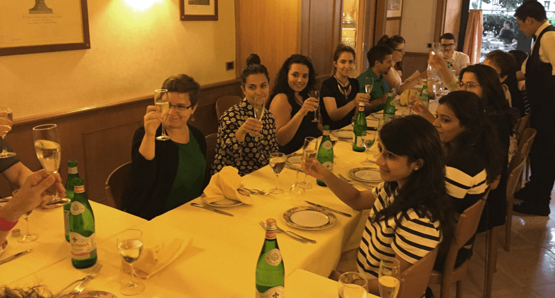 group of students holding wine glasses