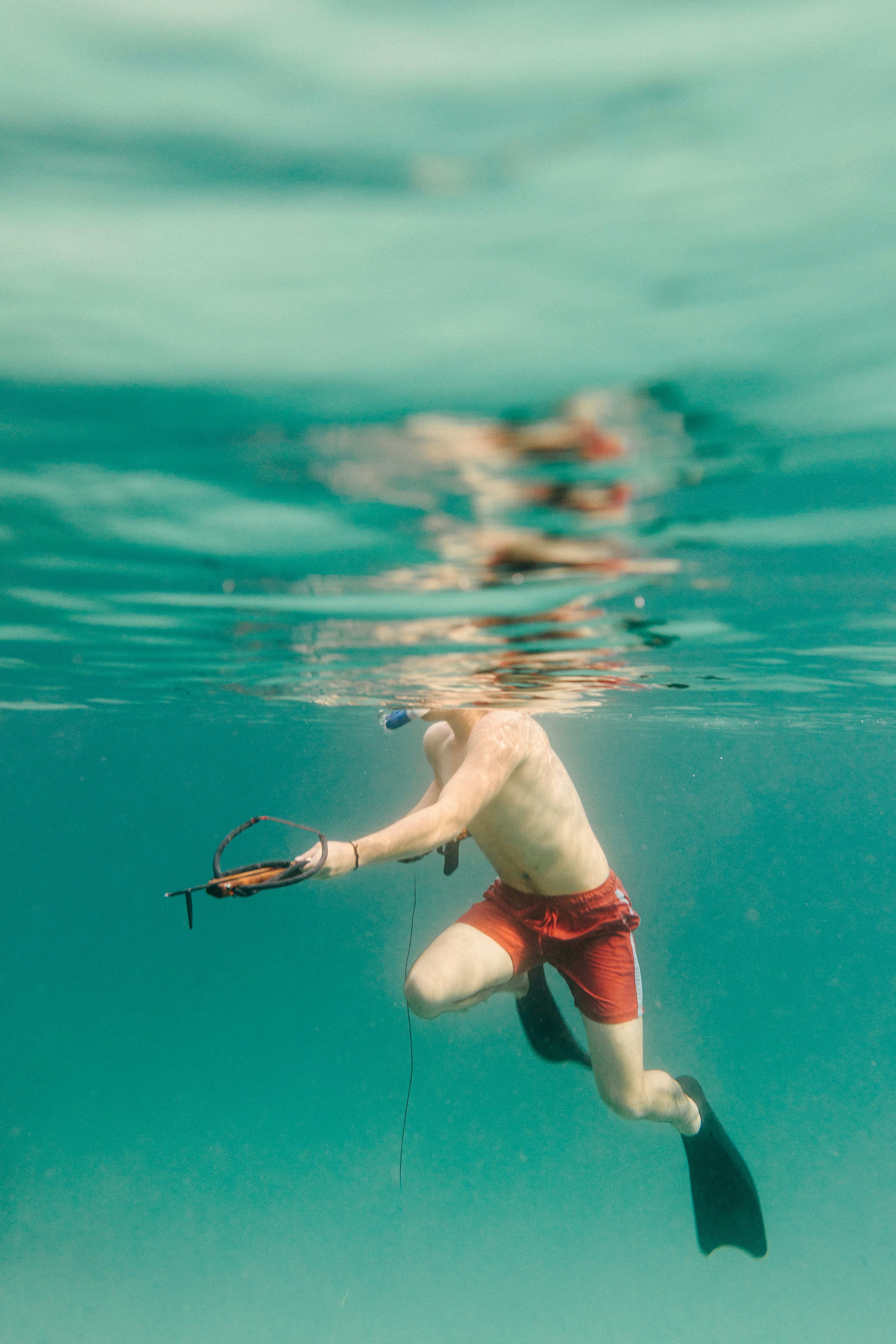 a man in a red swimsuit is swimming in the water