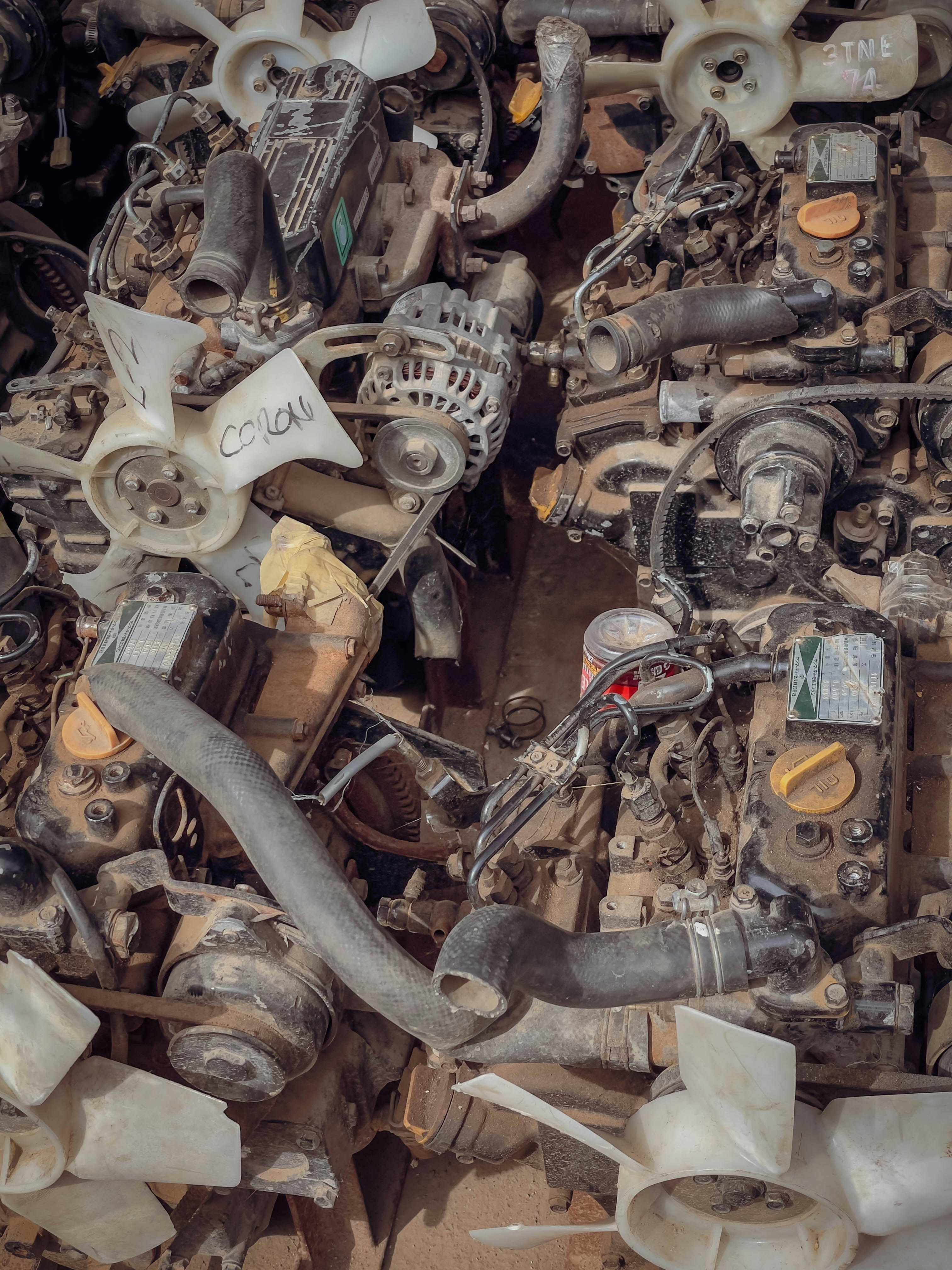 Pile of dirty, used car engines and parts