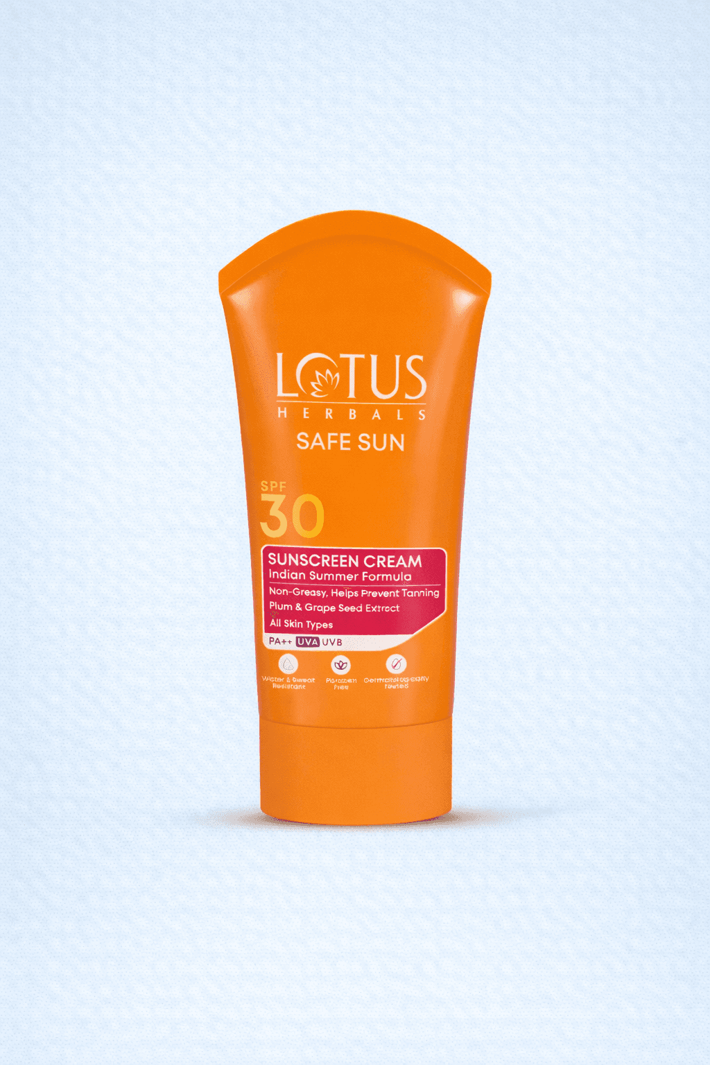 A smiling woman with her arms crossed, standing against a dark green background. She has long, dark hair.