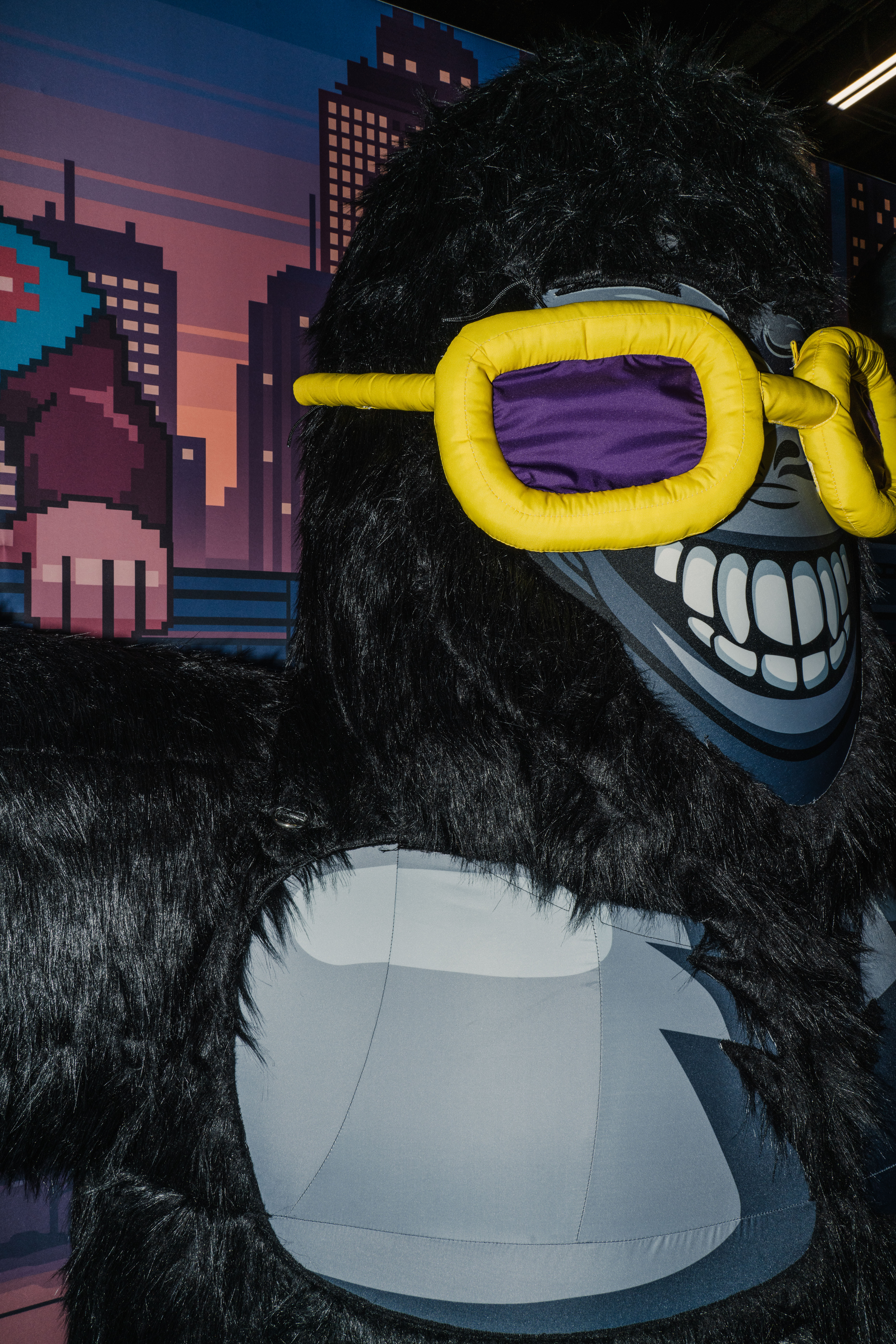 Inflatable gorilla statue with fur and yellow glasses.