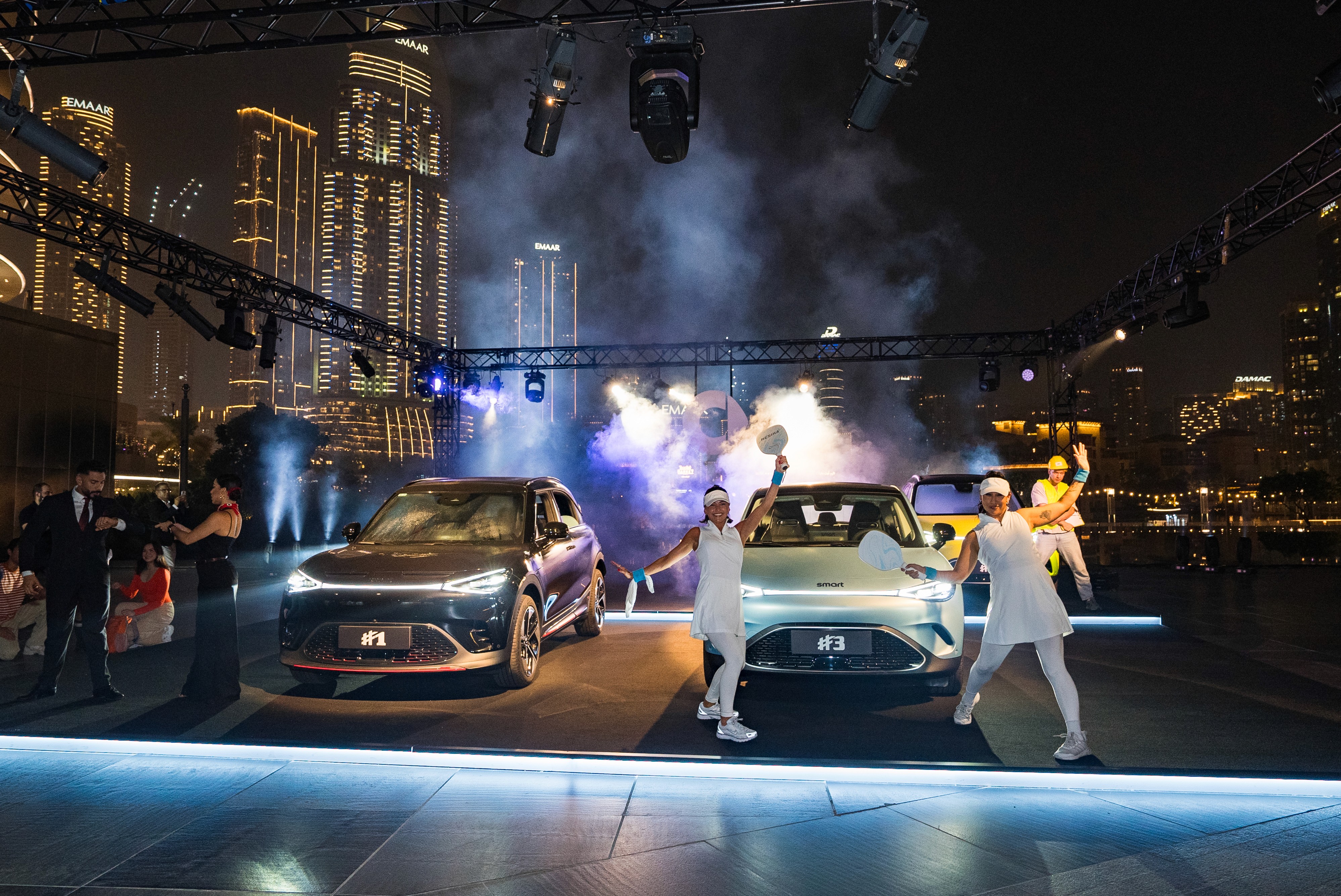 smart car reveal flashmob in Dubai with smart #1 and smart #3 vehicles, tennis costume dancers, business themed performers, and construction worker character on stage