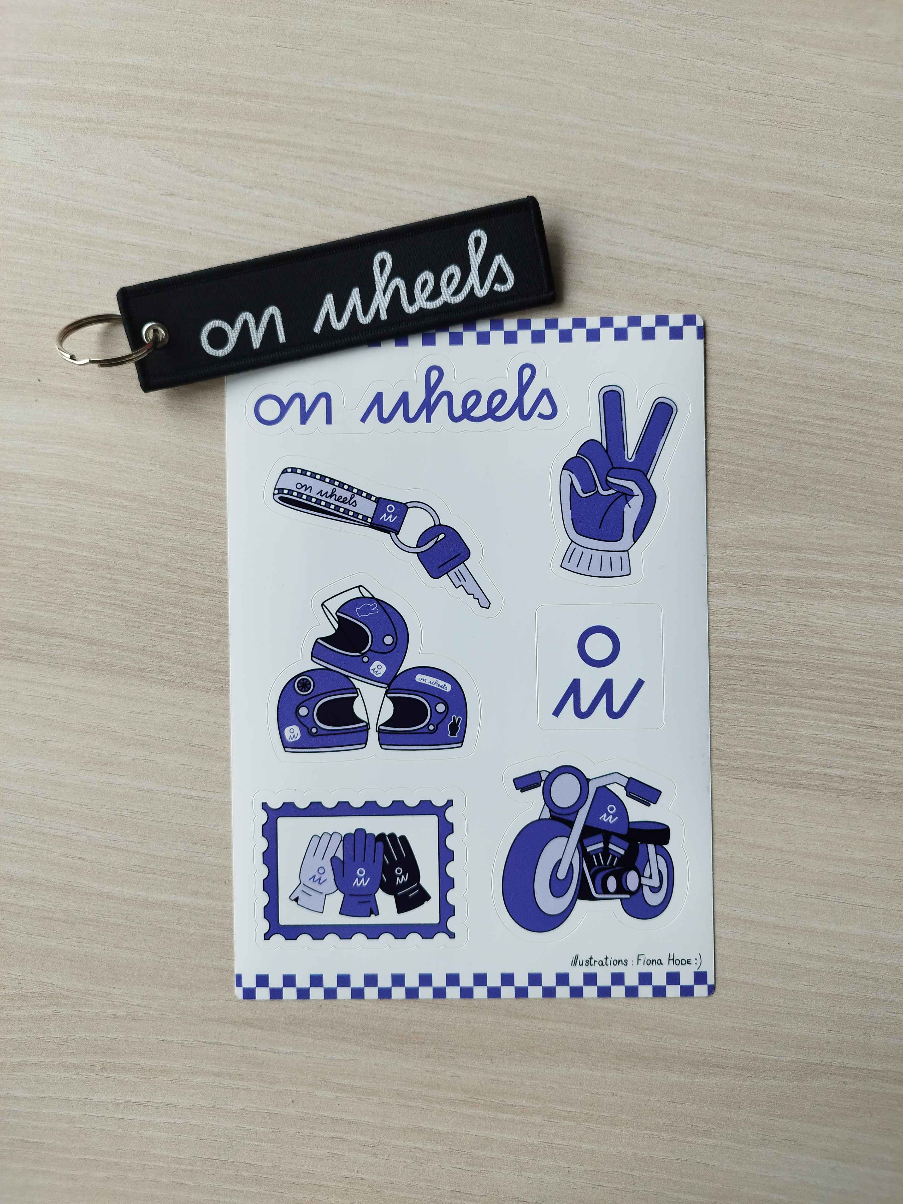 Planche de stickers On Wheels avec illustrations moto casque gants et logo