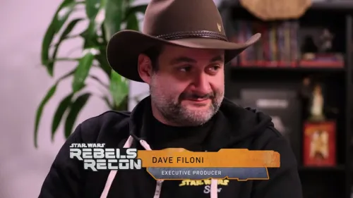 Dave Filoni in a cowboy hat and black sweatshirt with a "Rebels Recon" logo beneath him