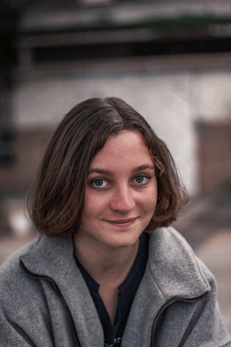 Close-up smiling portrait with visible street background