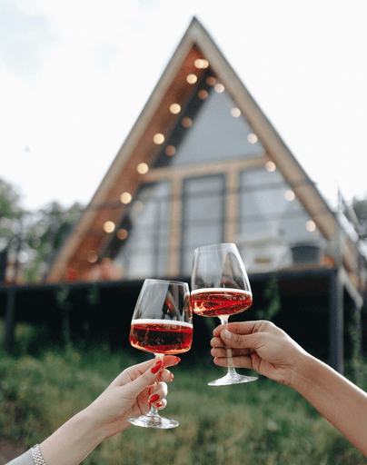 a couple of hands holding wine glasses