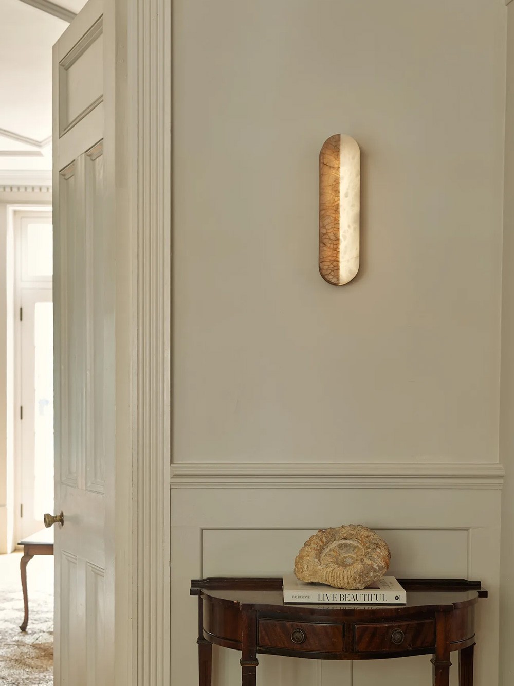 Dua wall light – round alabaster form with soft backlit glow and visible veining
