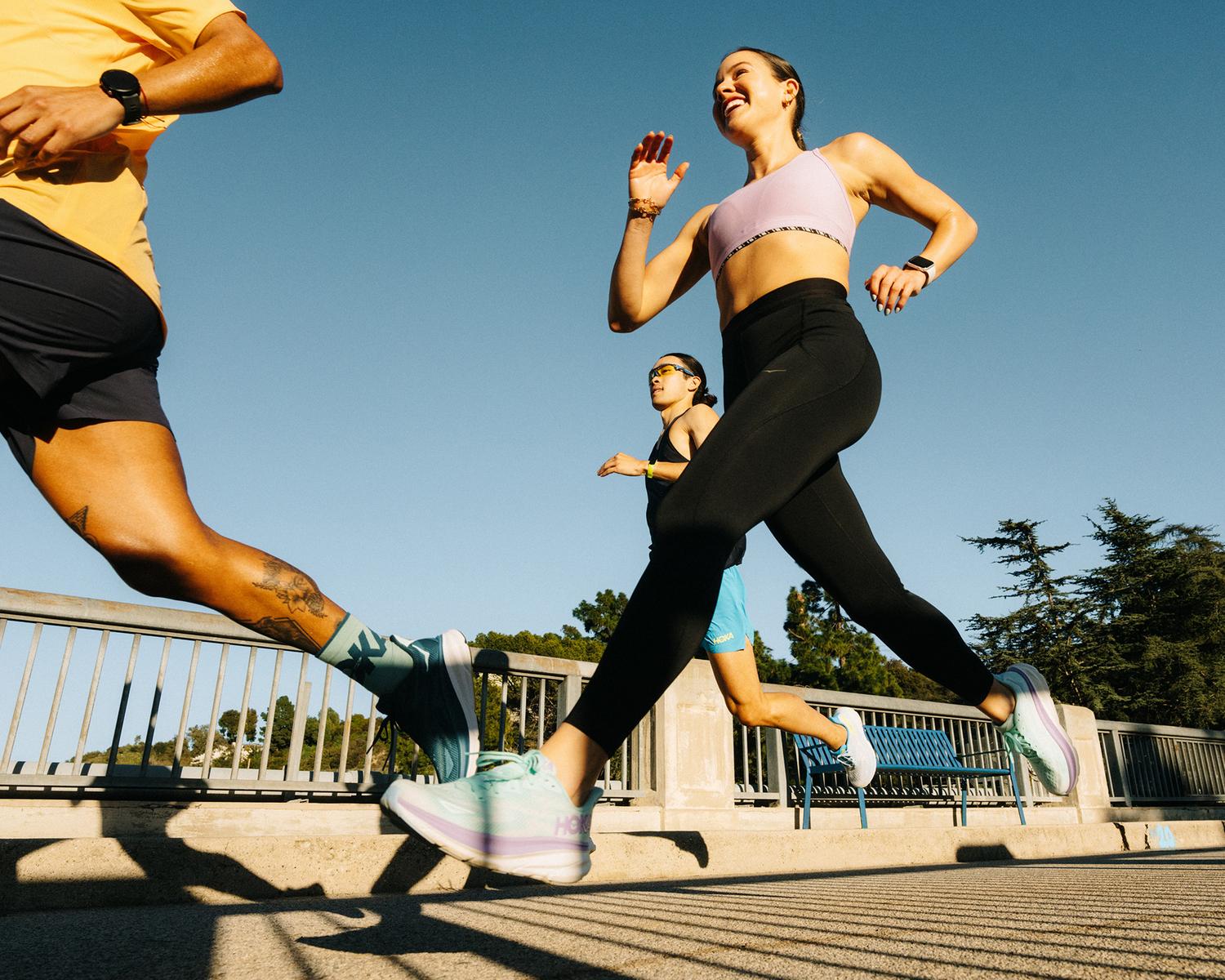 Smiling man and woman standing together in front of a framed abstract artwork.
