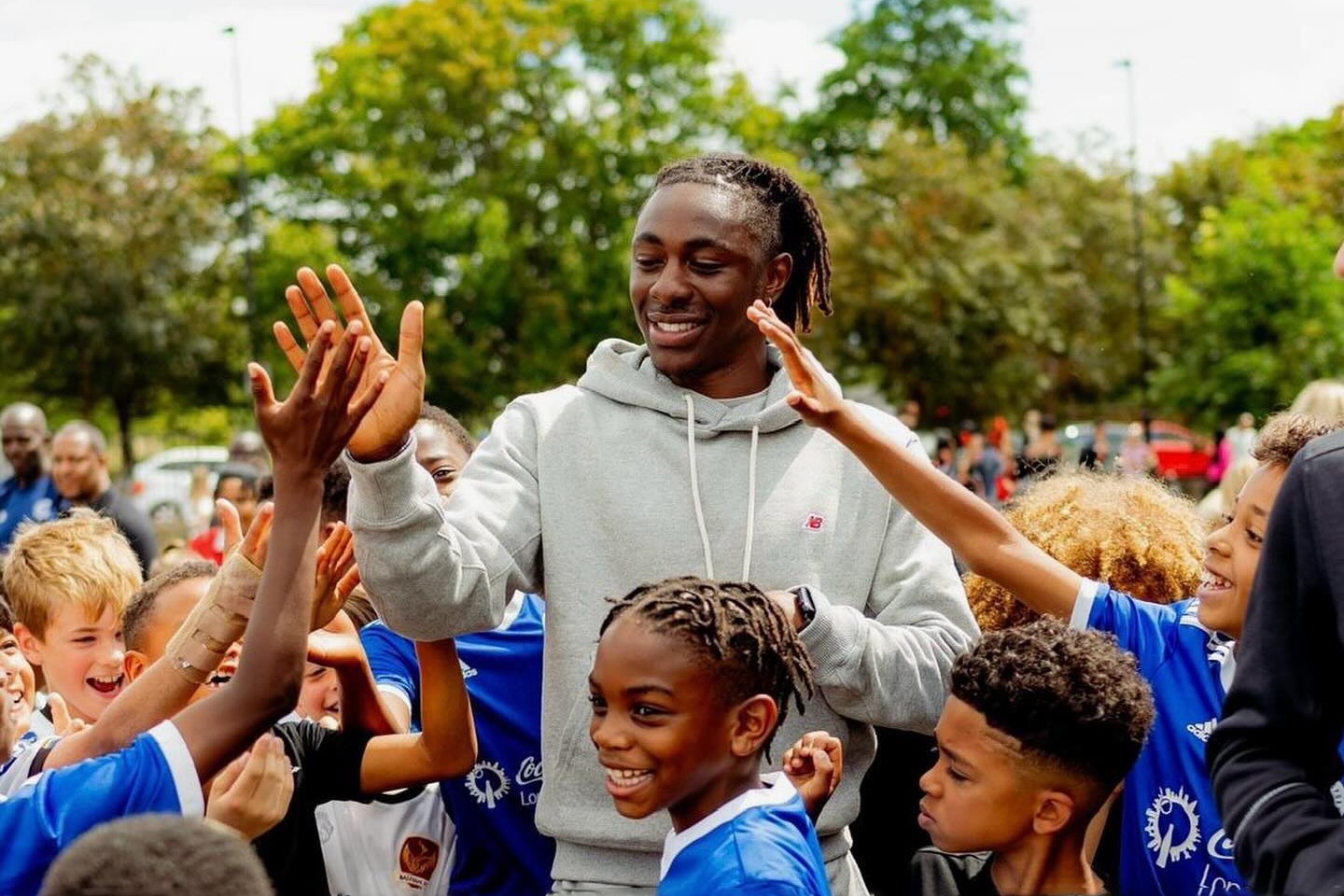 woman holding a phone and man looking at the phone. both are smiling