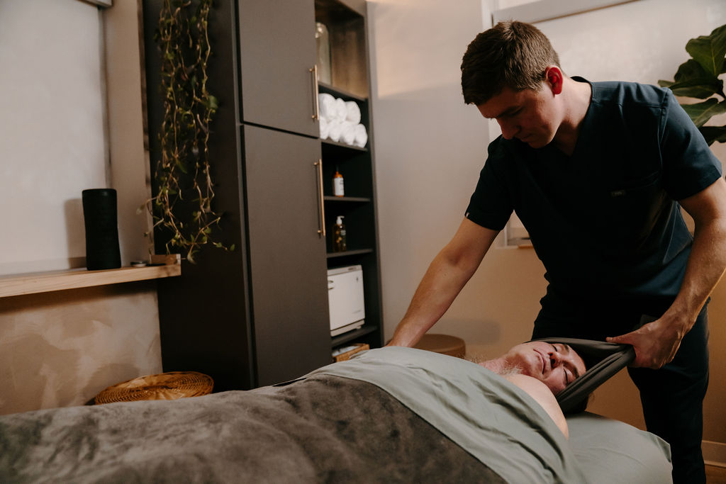 Person recieving massage therapies on spine