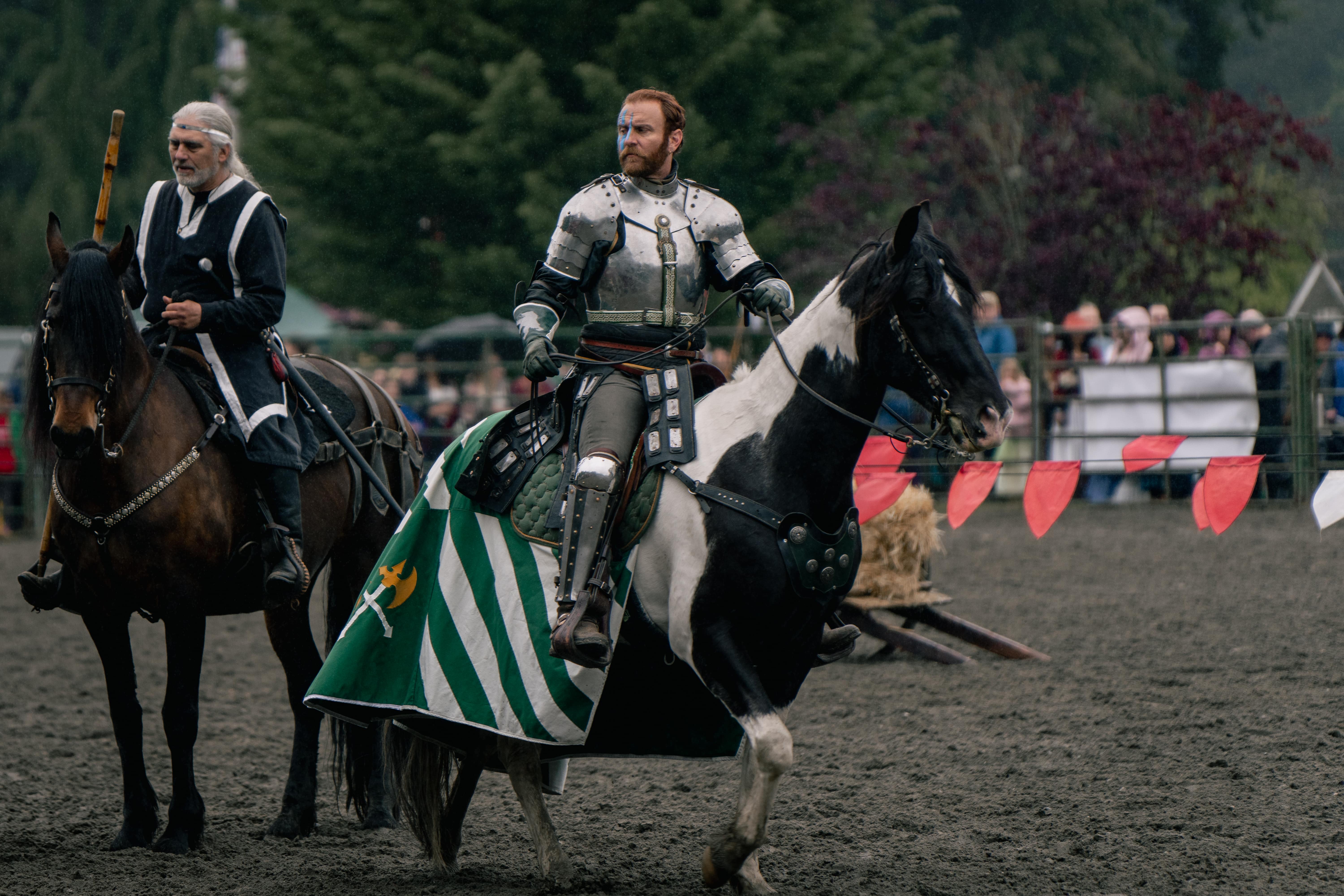 Knight in armor jousting on horseback at Whidbey Renaissance Faire