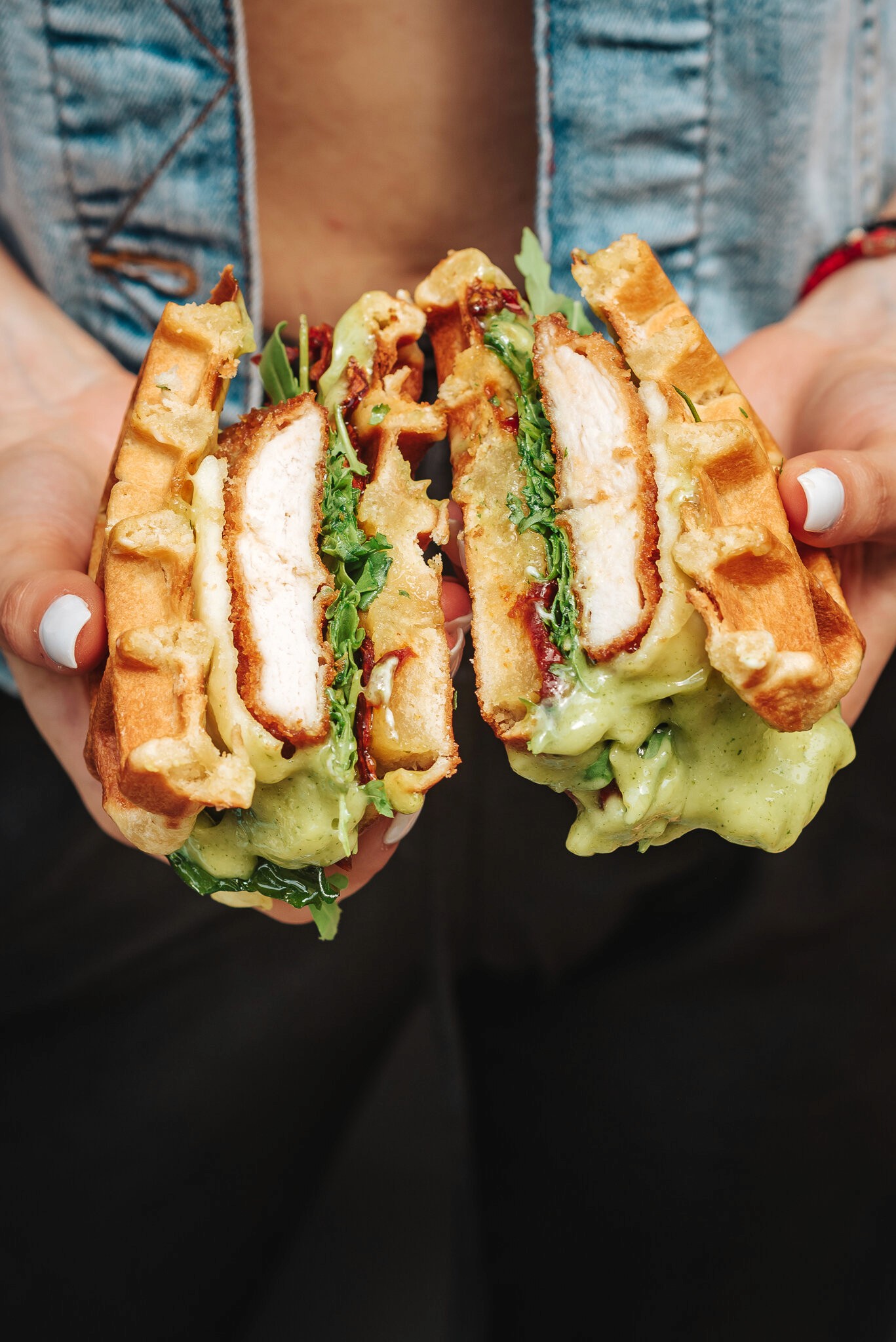 Modern home office setup with a monitor, ergonomic chair, keyboard, and indoor plants near a window with blinds.
