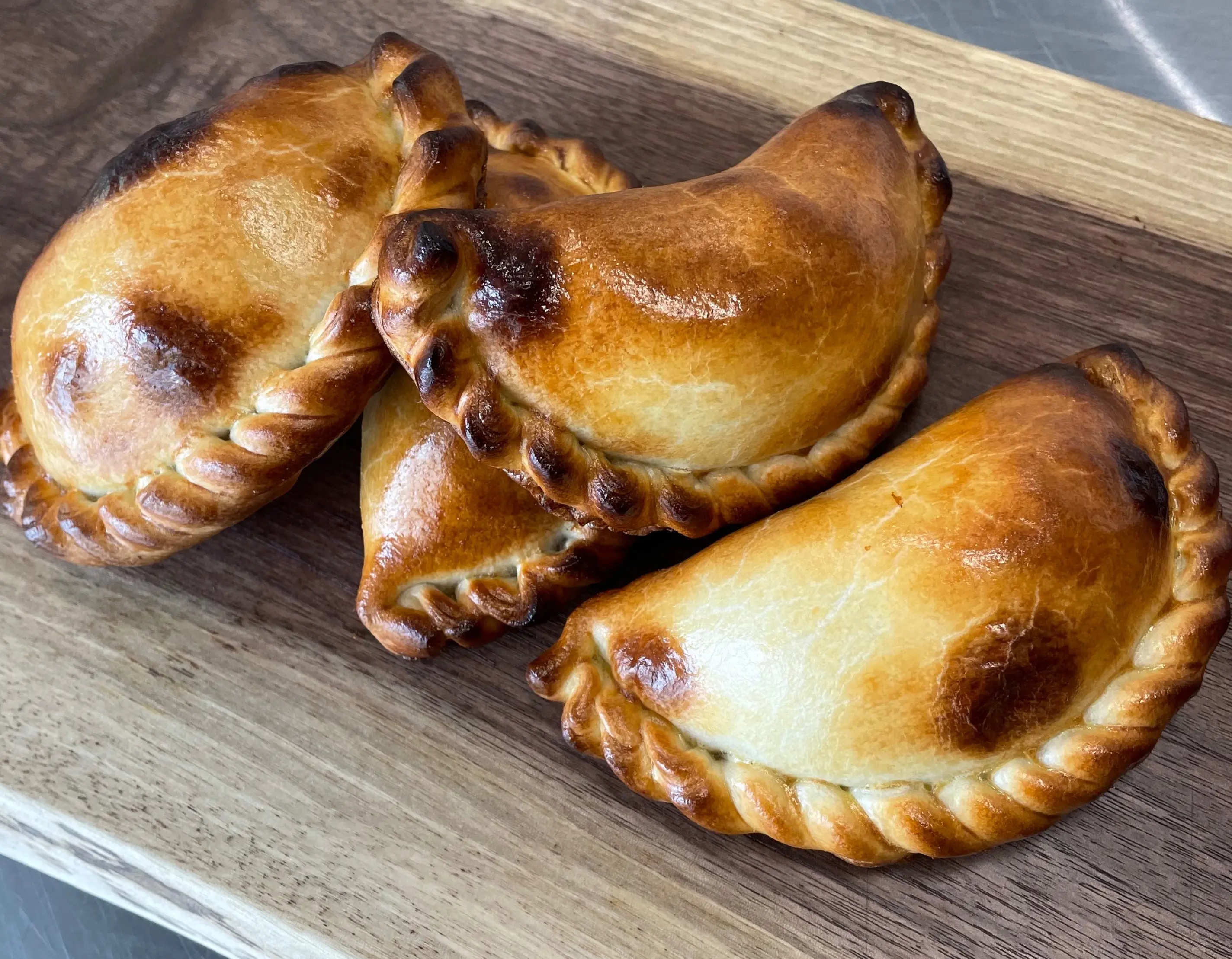 Fresh golden baked artisan empanadas by Scorpion Chef Vancouver Island