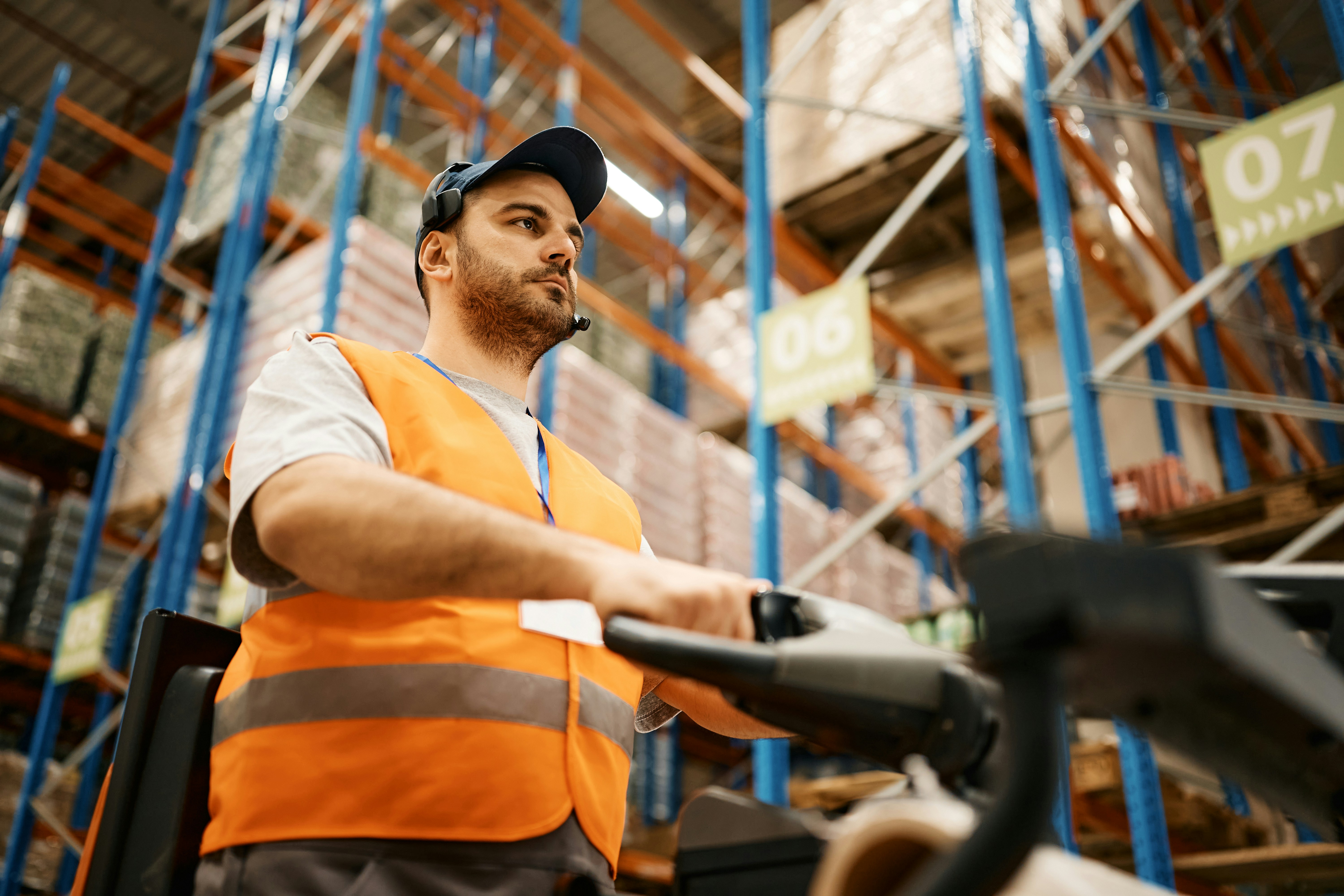 warehouse worker driving a pallet truck