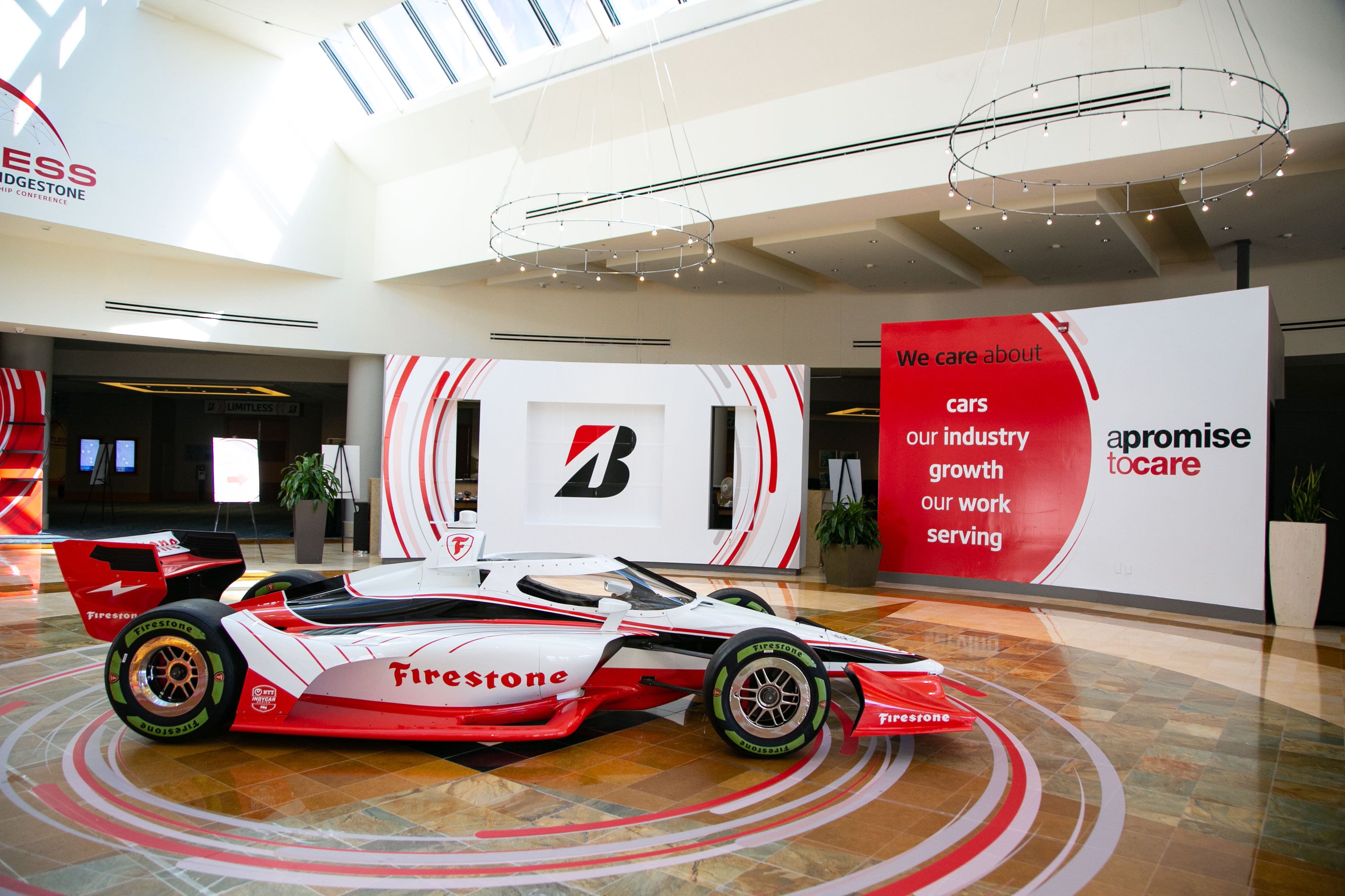 Bridgestone lobby entrance with themed logo signage and race car