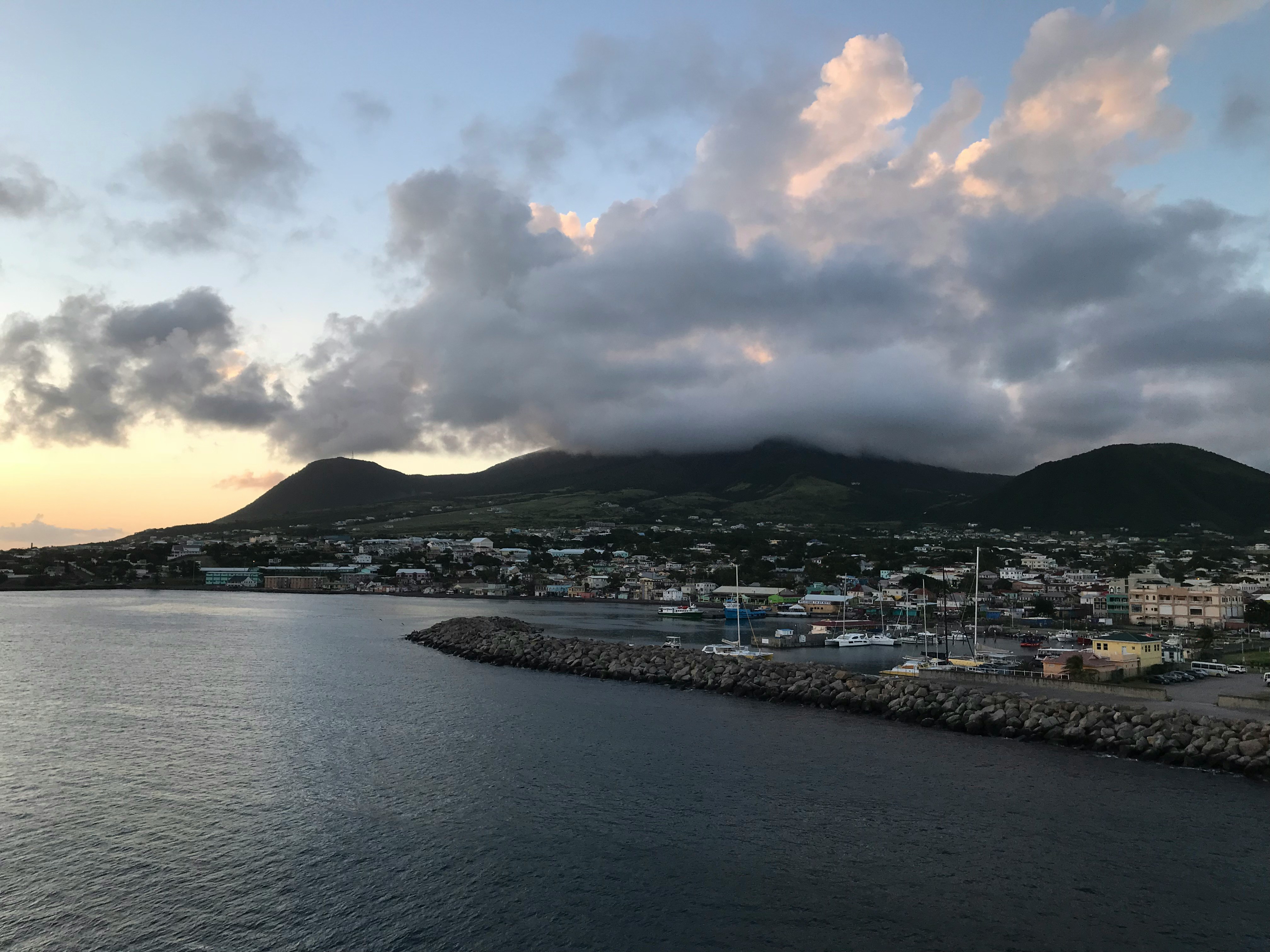 landscape photography of city by the sea under cloudy sky