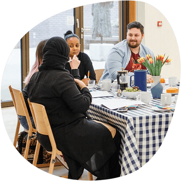 People sitting at a table with their food and drinks.