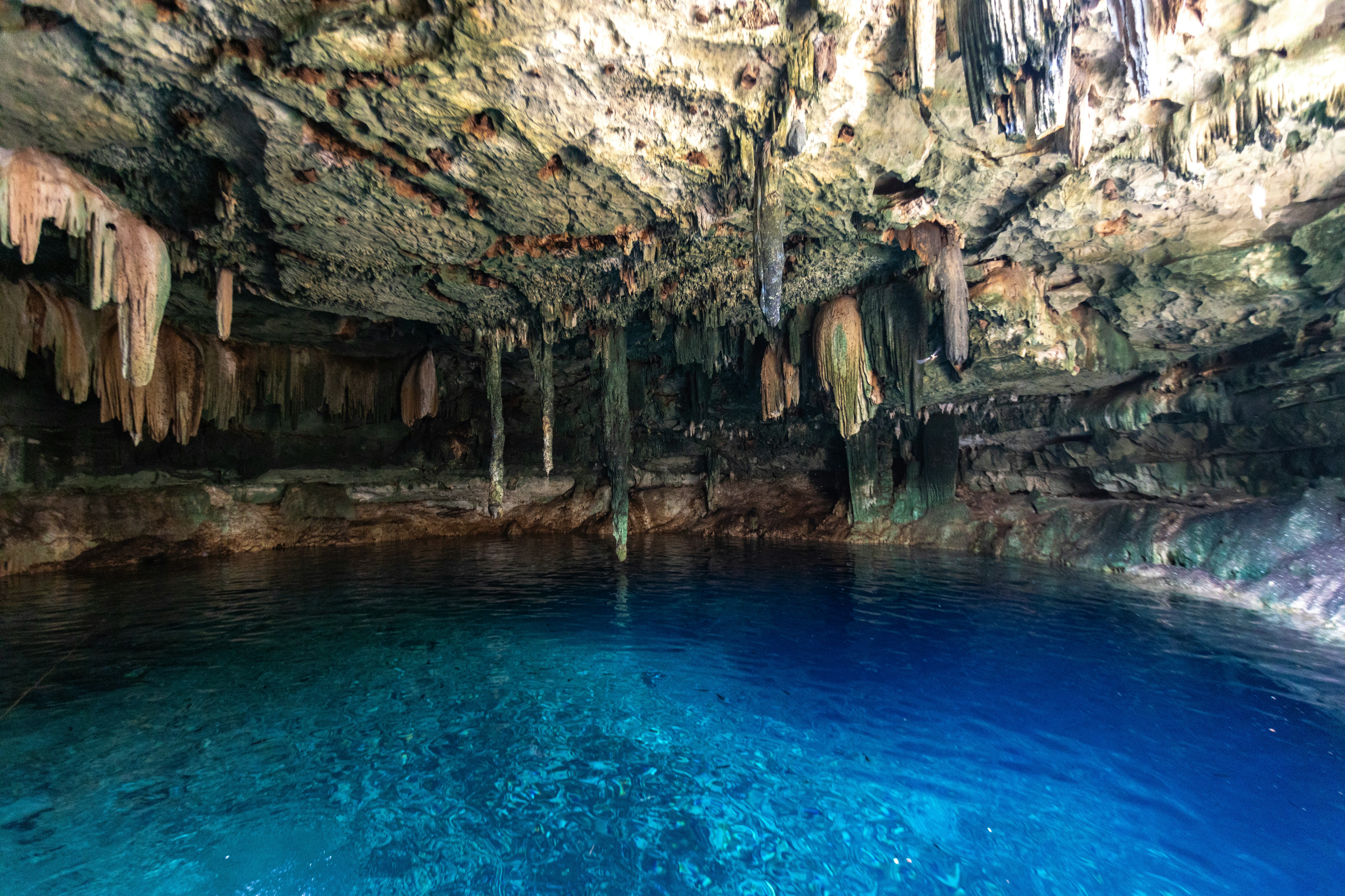 A cave filled with blue water and lots of caves