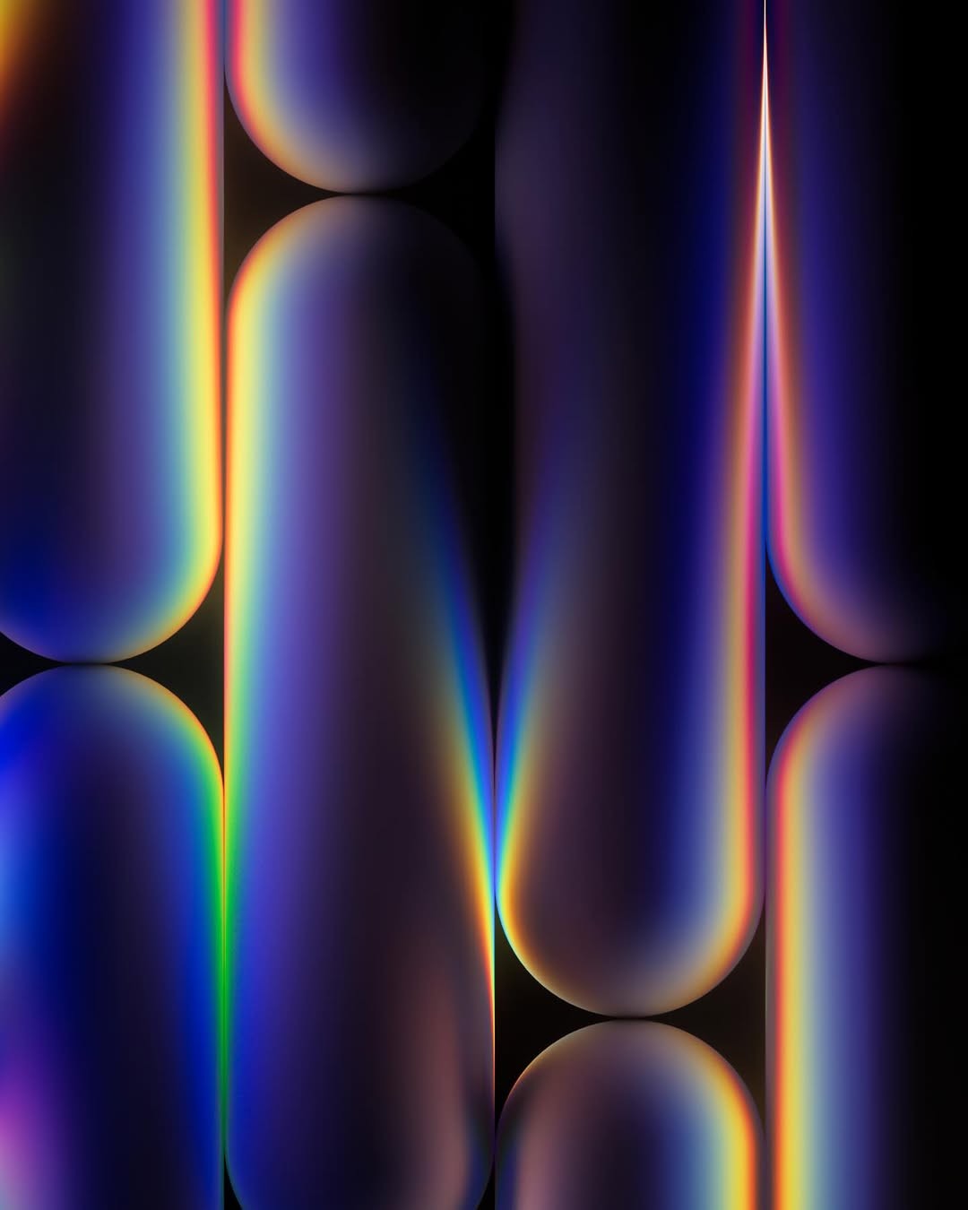 A person sitting at a desk smiles while using a smartphone, with a laptop and coffee cup nearby.