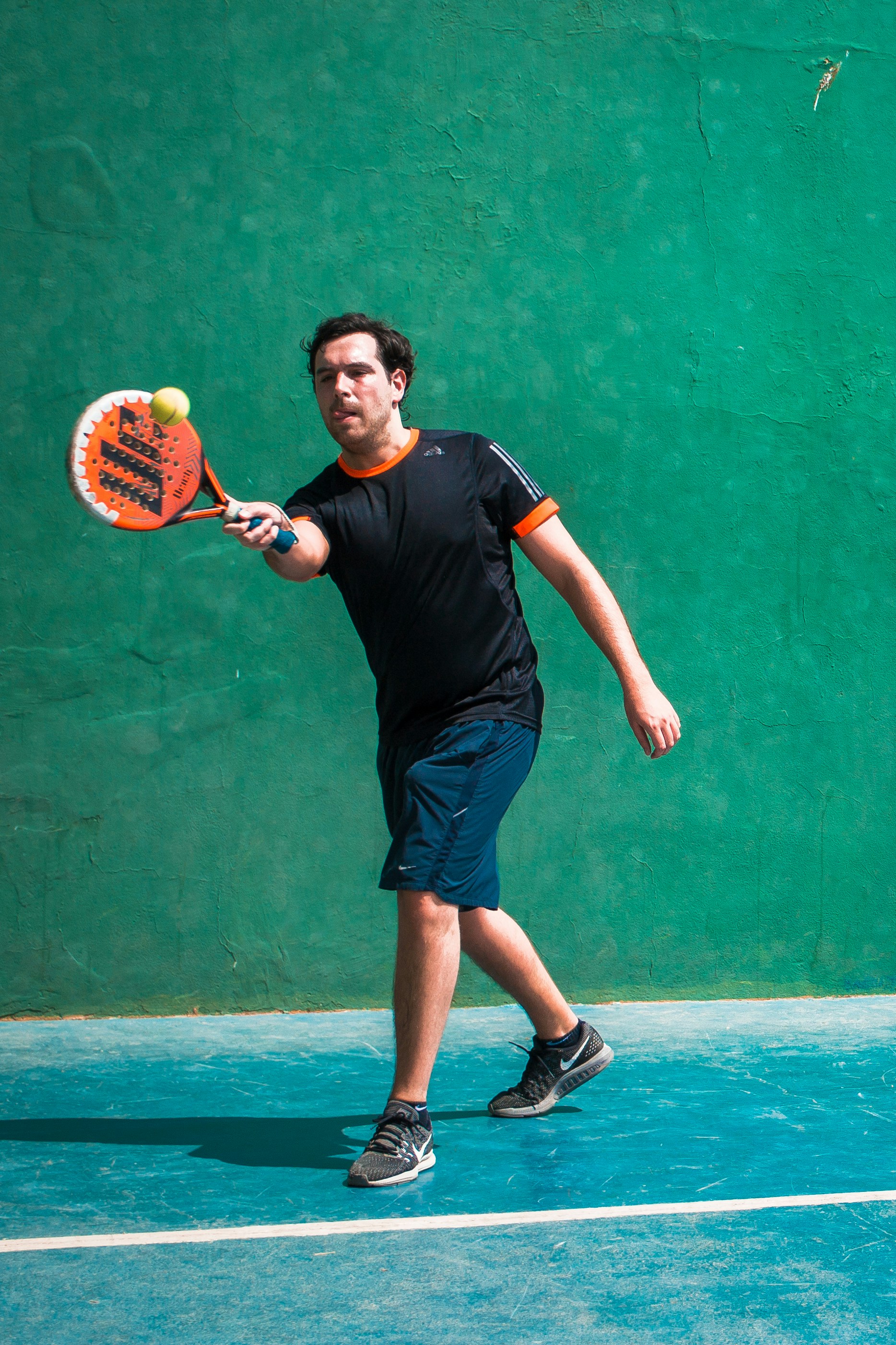 a man holding a tennis racquet on a tennis court
