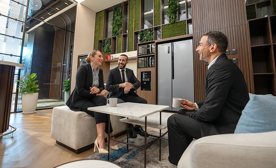 Professionals networking in a business lounge. Experience premium office space Abu Dhabi. Try virtual offices Abu Dhabi.