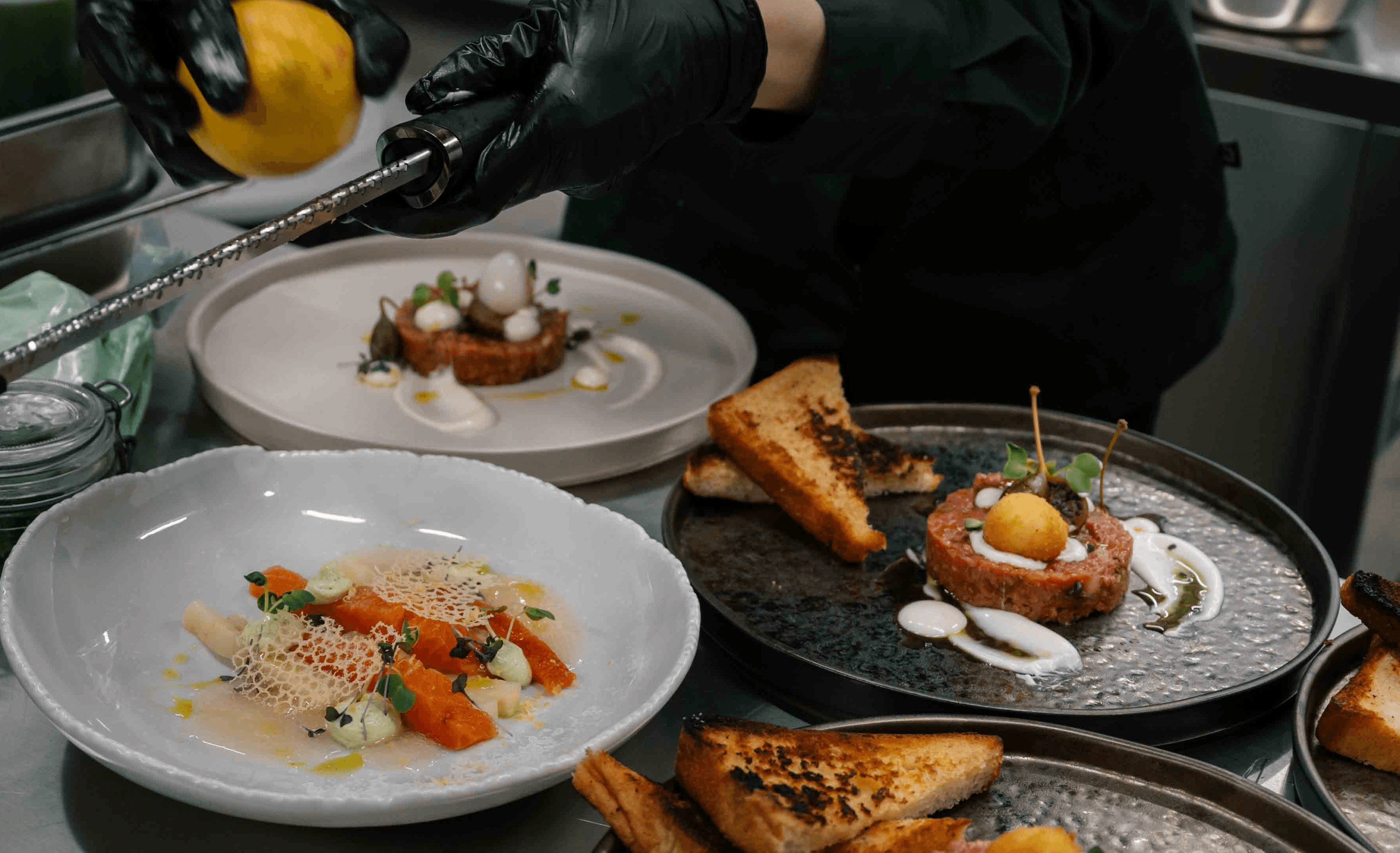 a glass of cocktail with a slime orange fruit