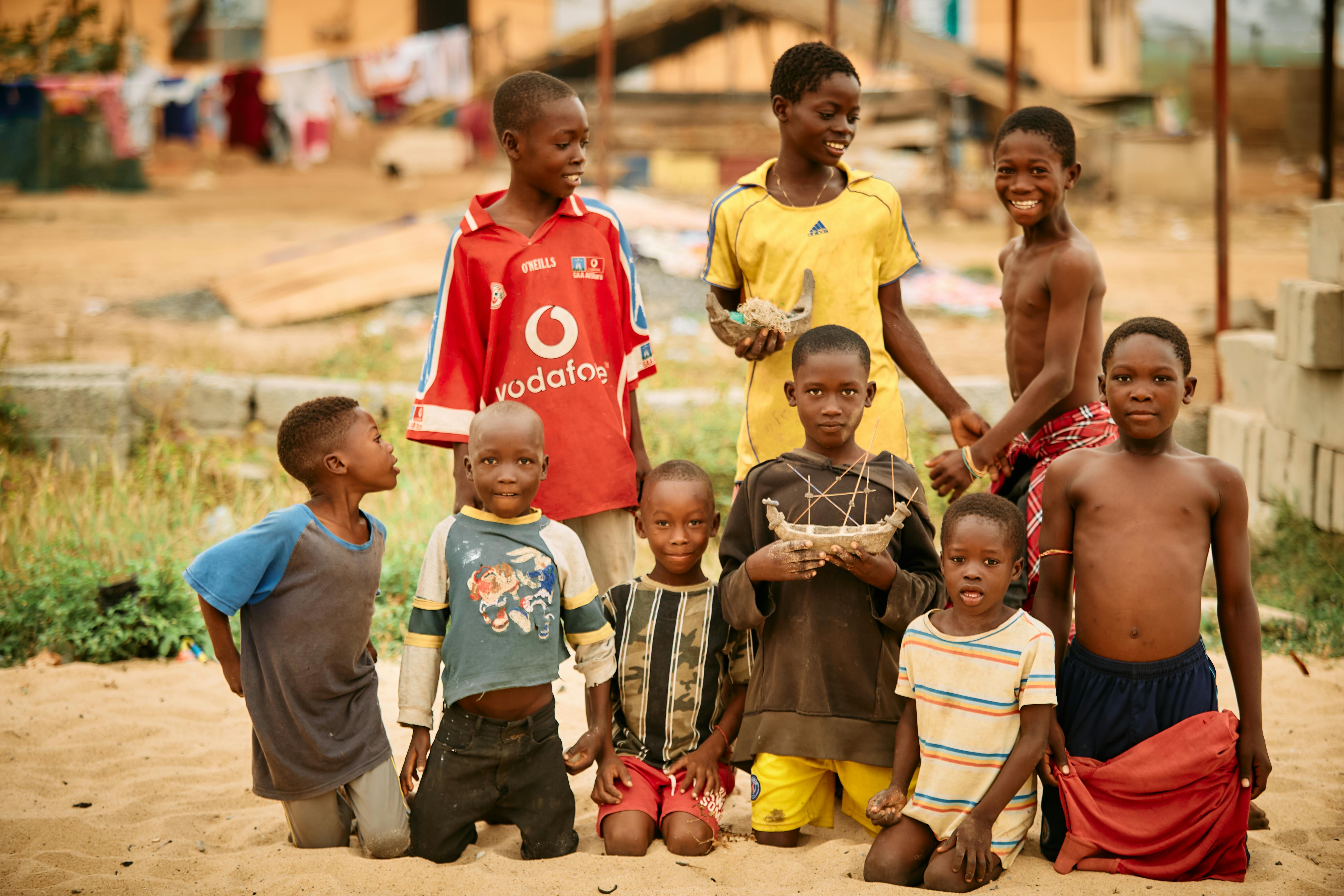 group of women in red and white dress standing on brown wooden bar during daytime
