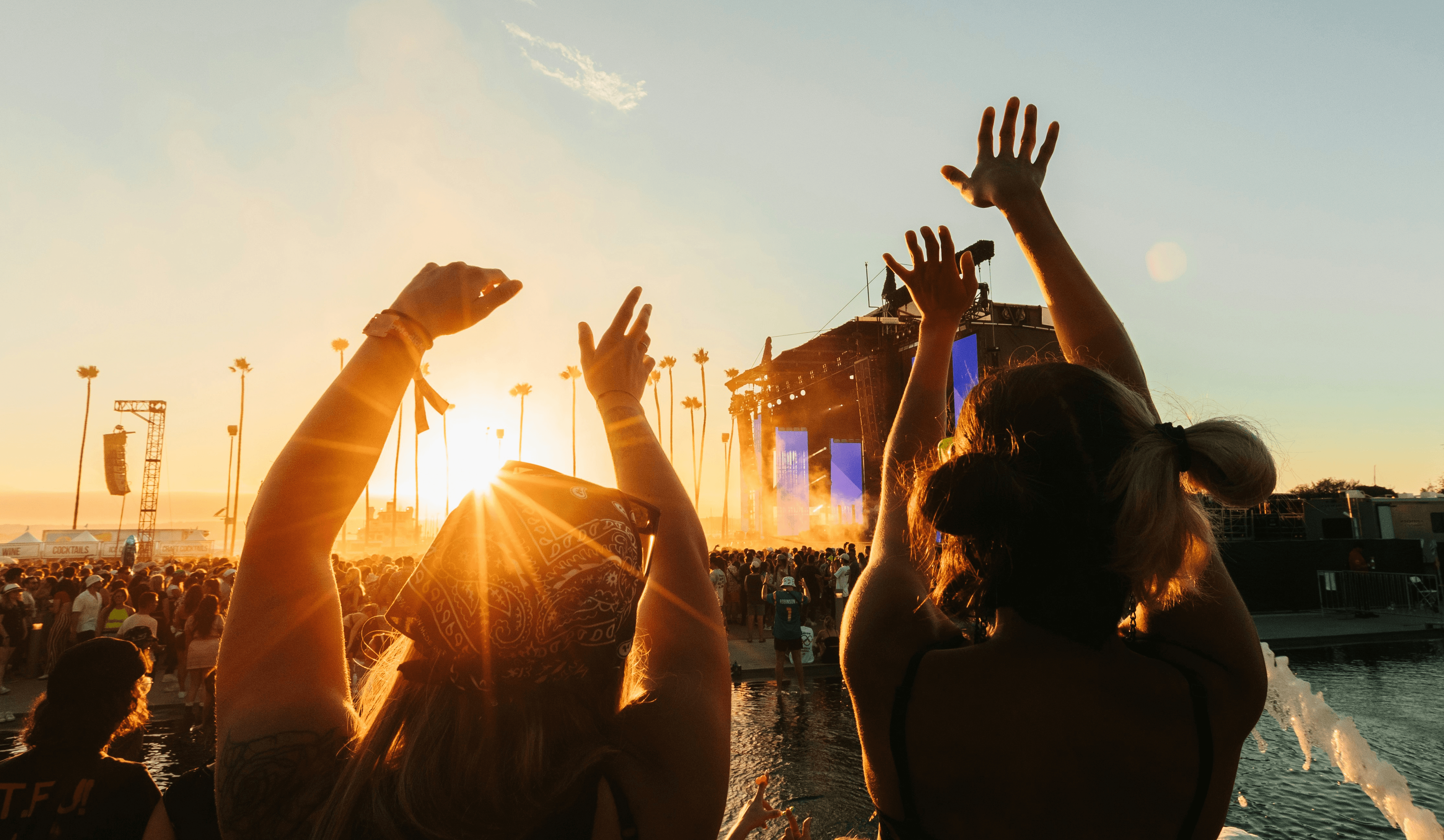 a group of people raising their hands in the air